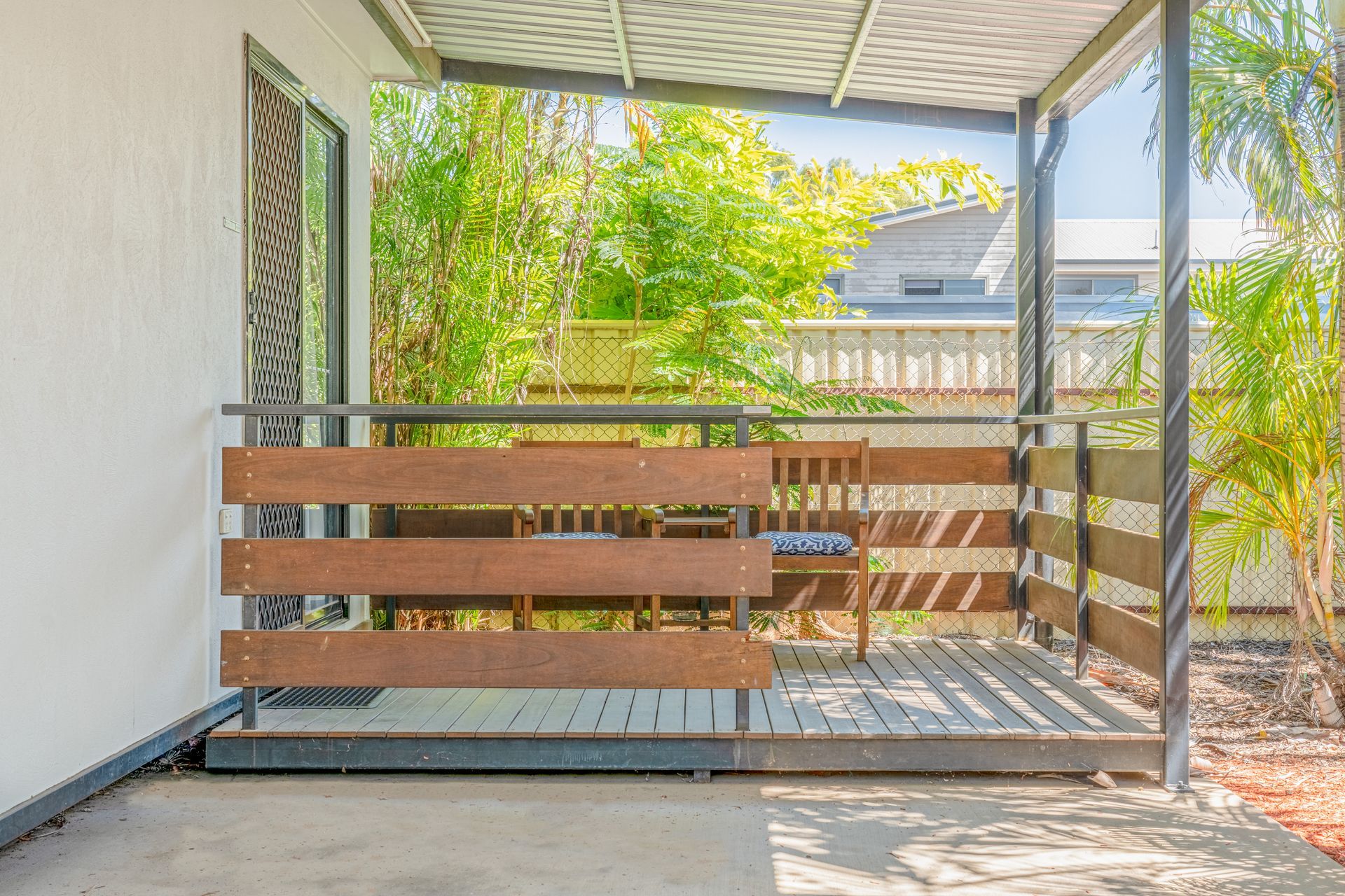 A balcony with a wooden railing and a canopy over it.