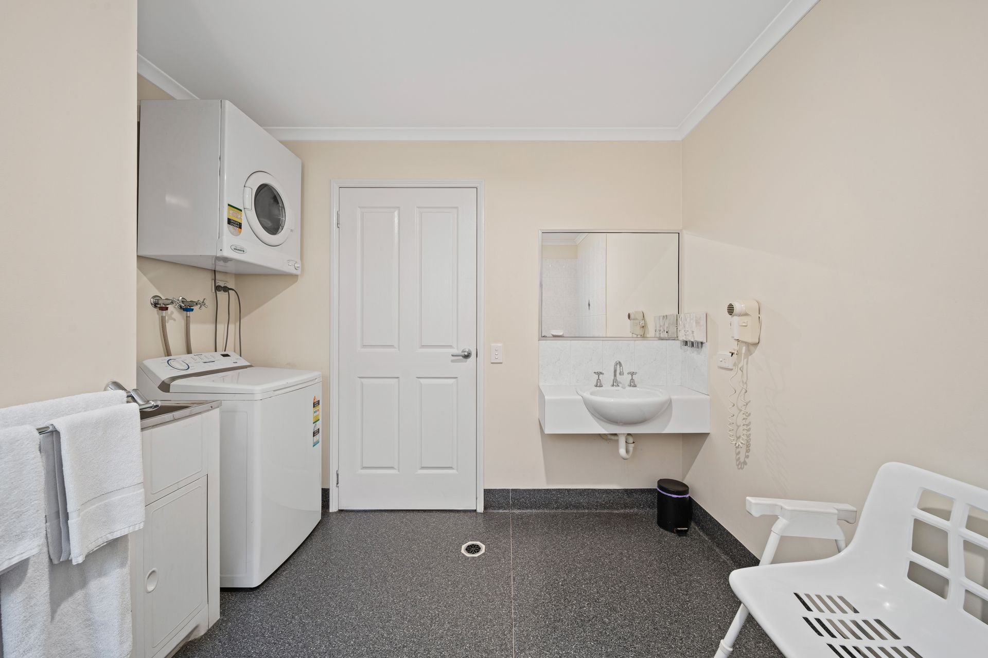 A laundry room with a washer and dryer and a sink.