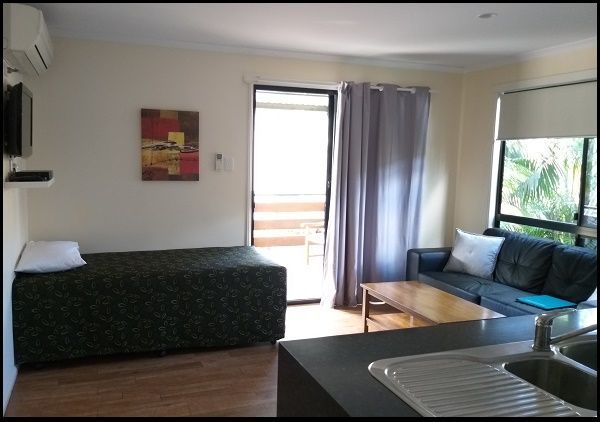 A living room with a couch and a bed