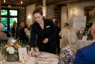 Event staff for hire at a fundraiser helping an attendee