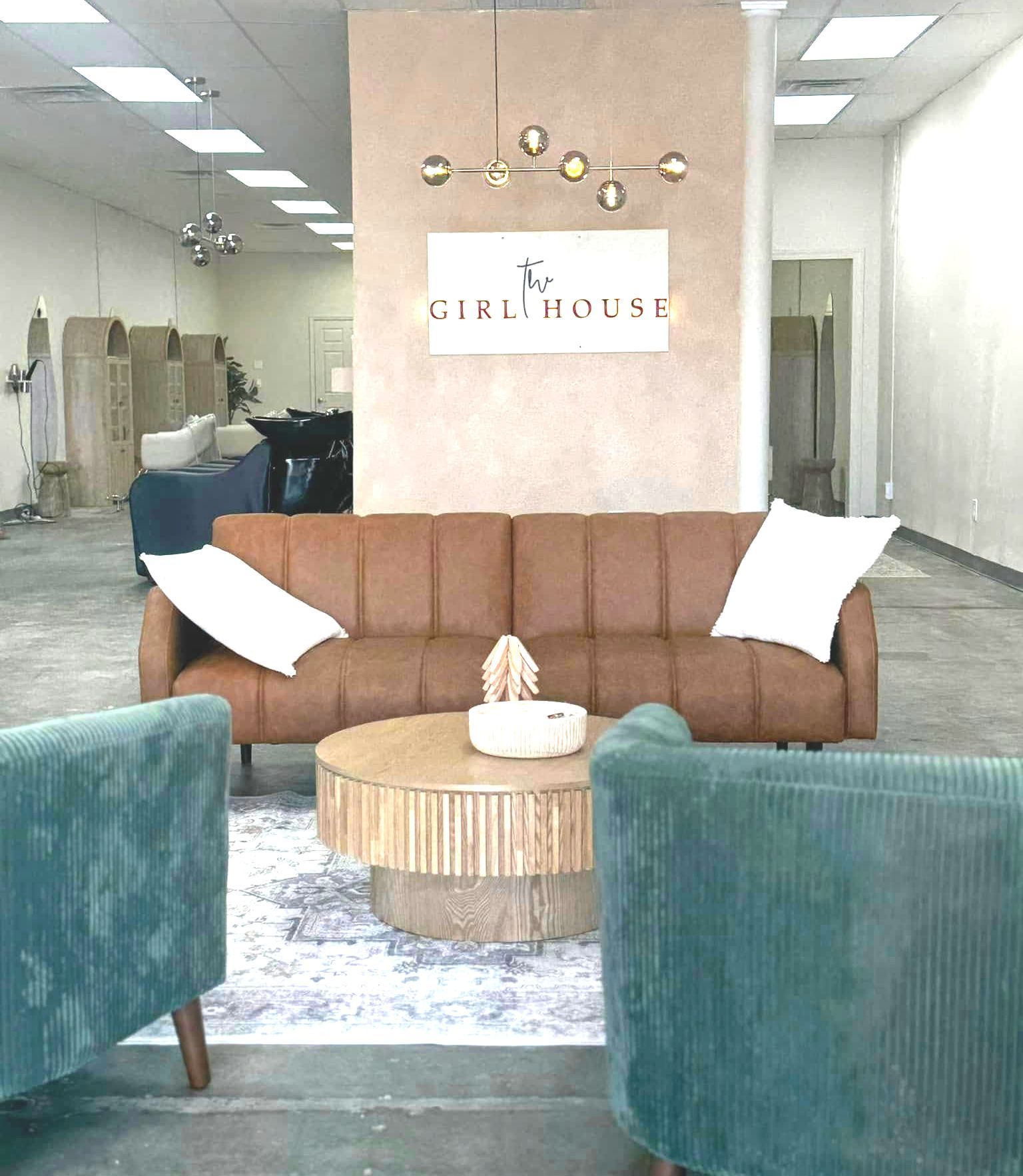 Brown leather couch and modern blue chairs in waiting room at The Girl House in Springfield MO