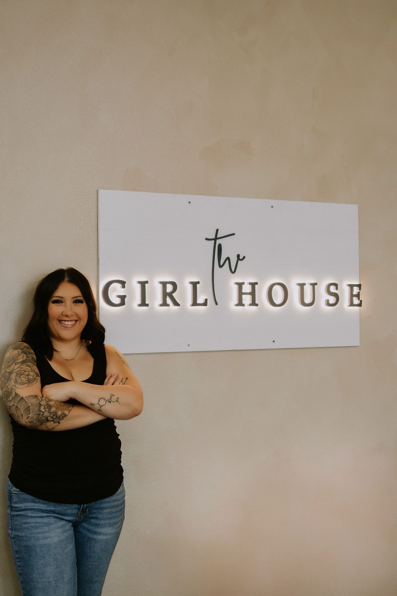 rikki hair stylist standing in front of the girl house sign in springfield mo