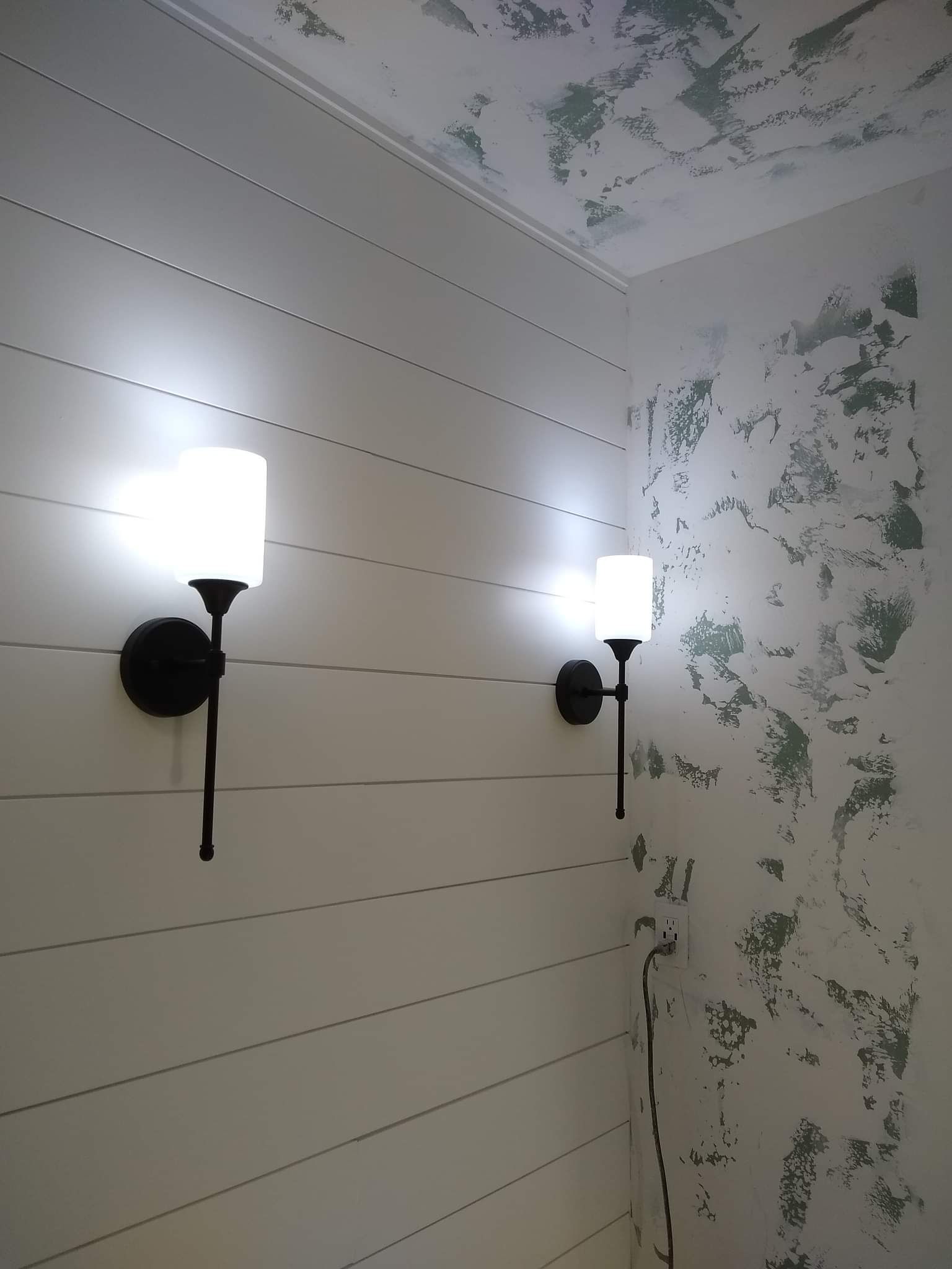Bathroom with a toilet, vanity, and tiled walls.