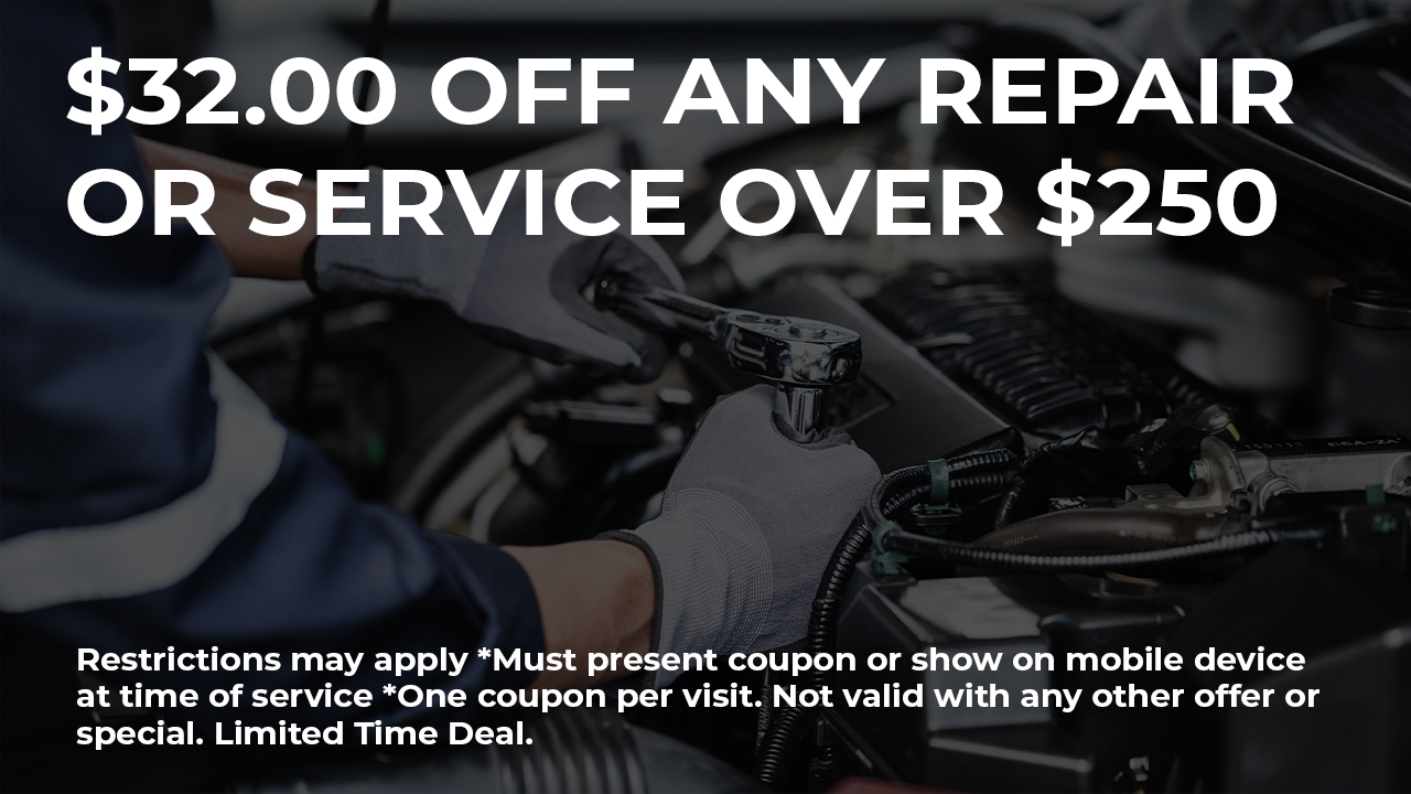 Coupon for $32 off any repair or service over $250. Mechanic working on car engine.