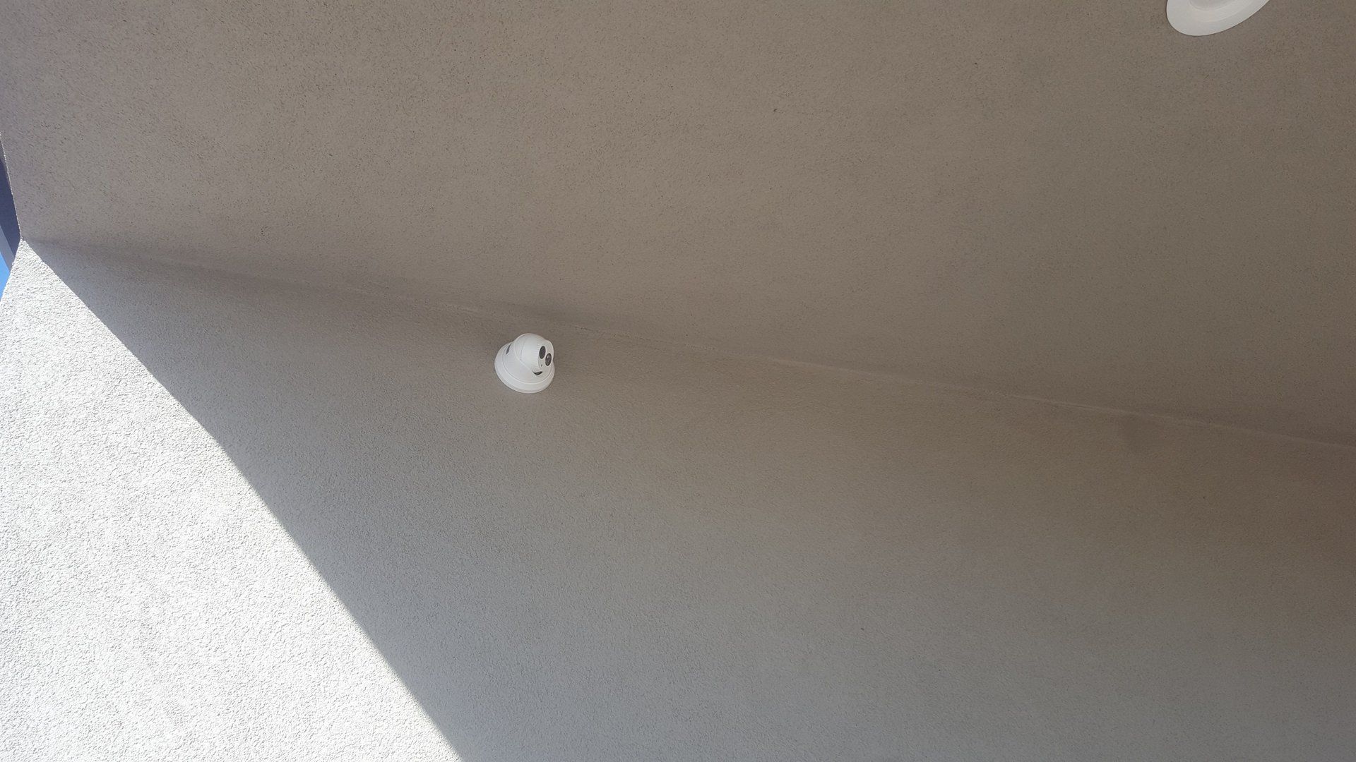 A close up of a ceiling with a hole in it.