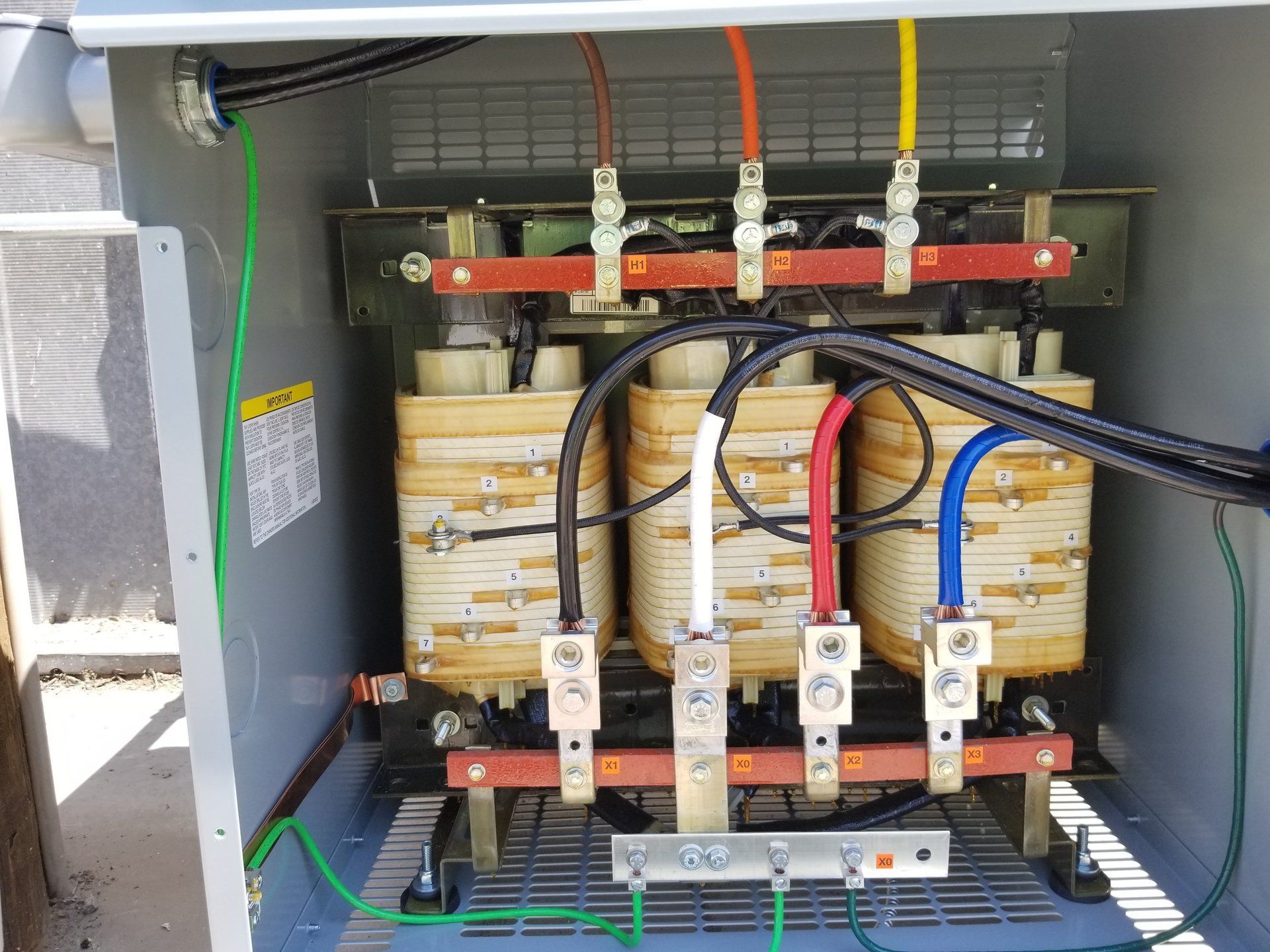 A close up of a transformer with wires coming out of it