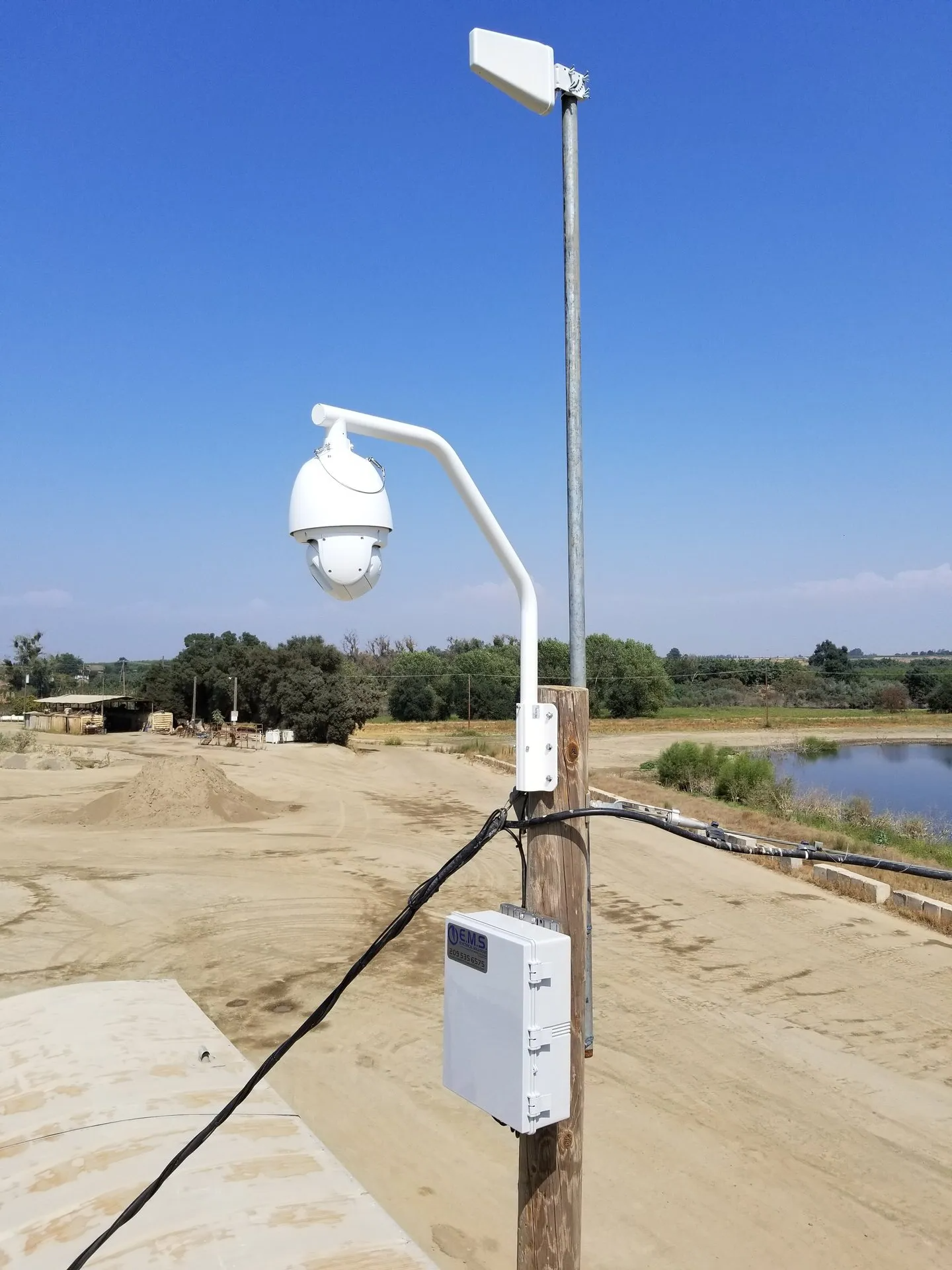 A camera on a pole with a box attached to it