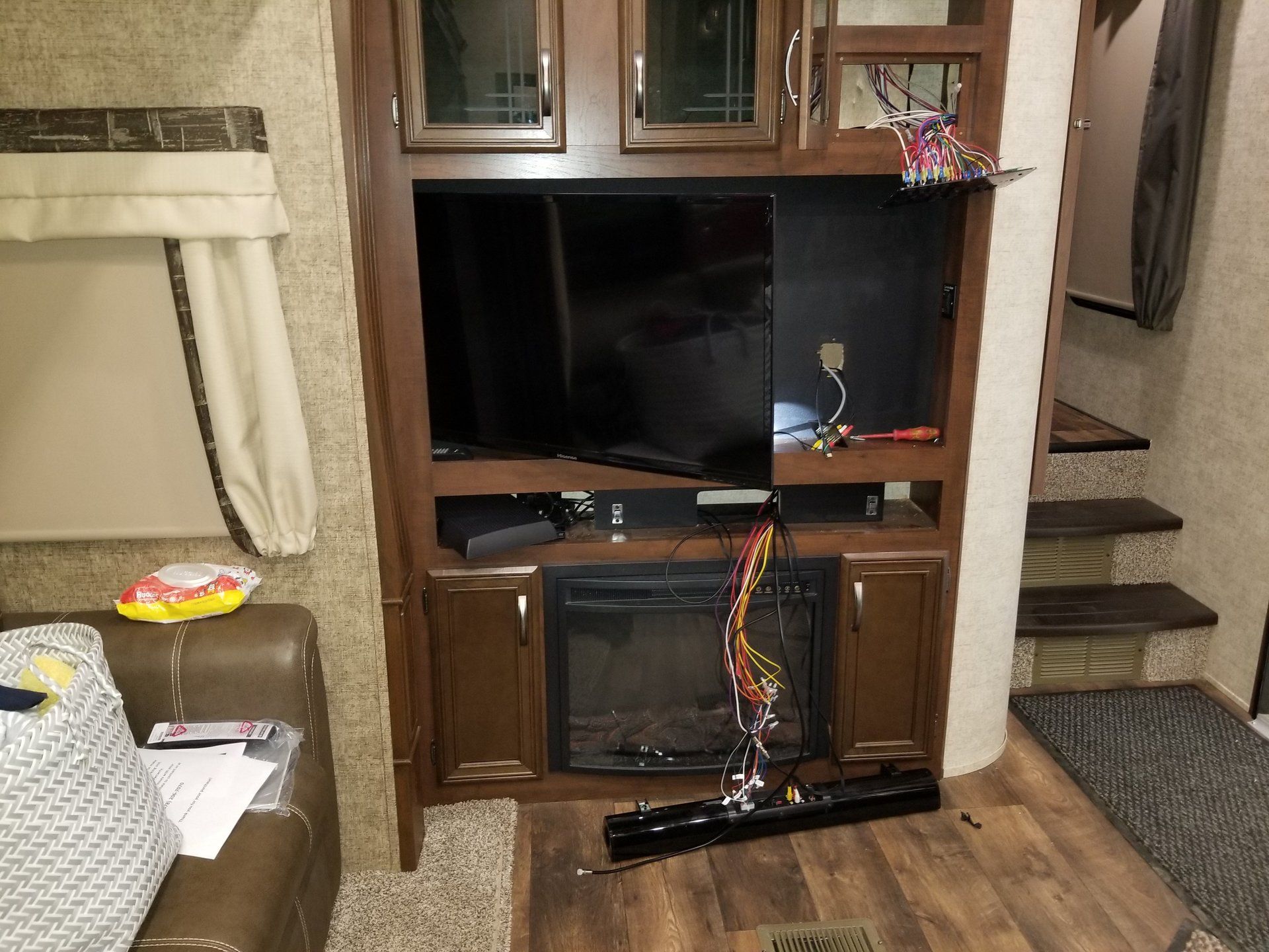 A living room with a fireplace and a flat screen tv.