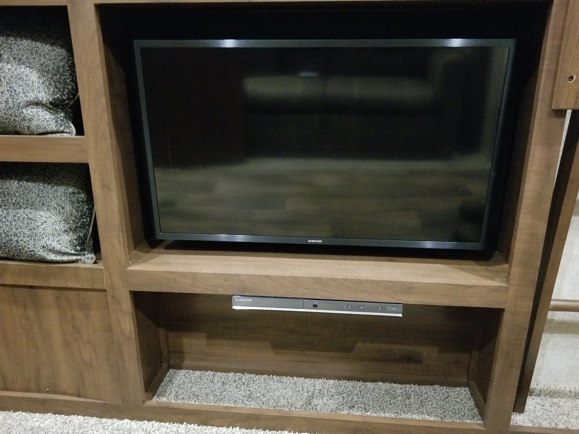 Ein Flachbildfernseher steht auf einem hölzernen Entertainment-Center