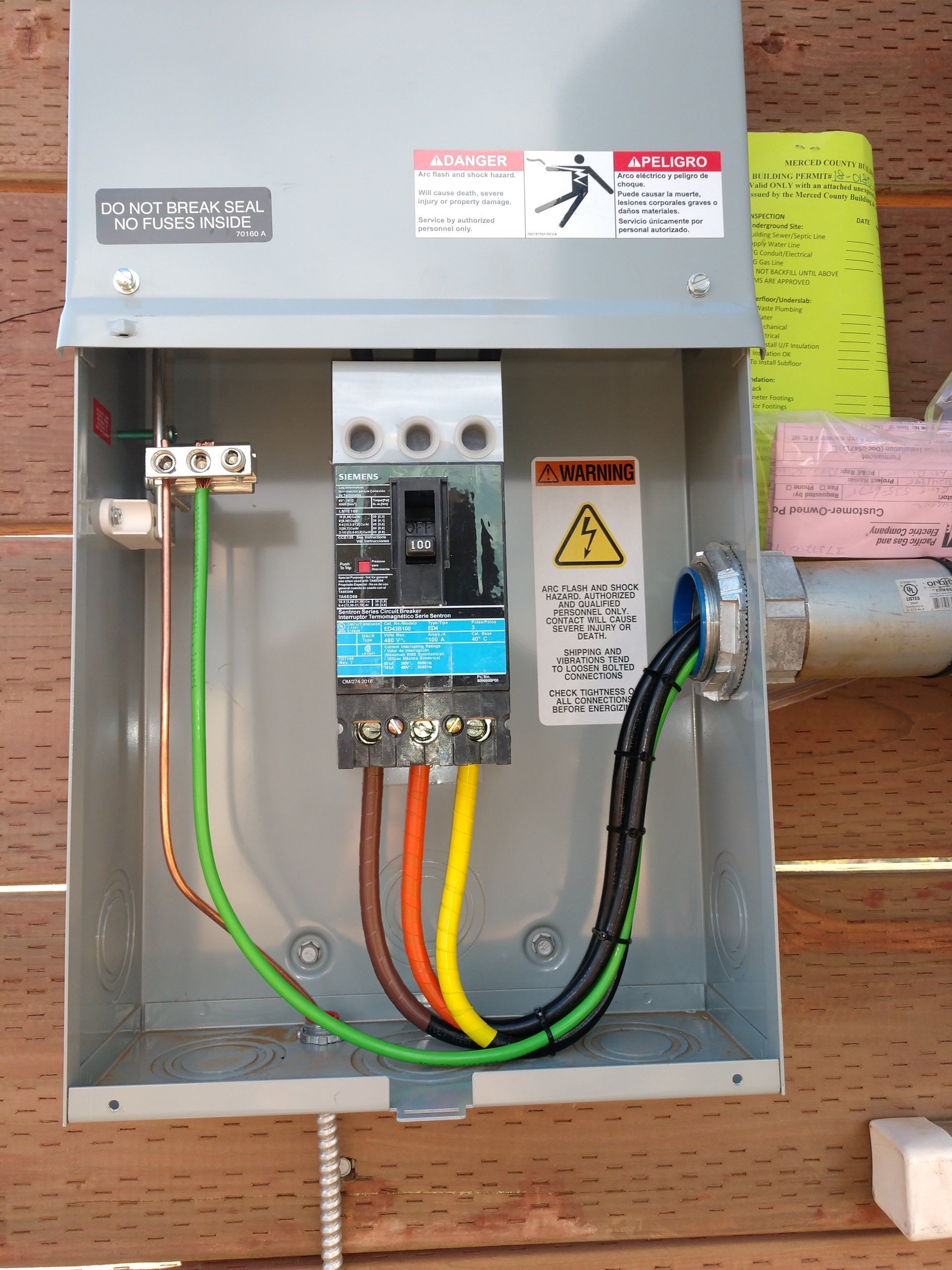An electrical box with a warning label on it