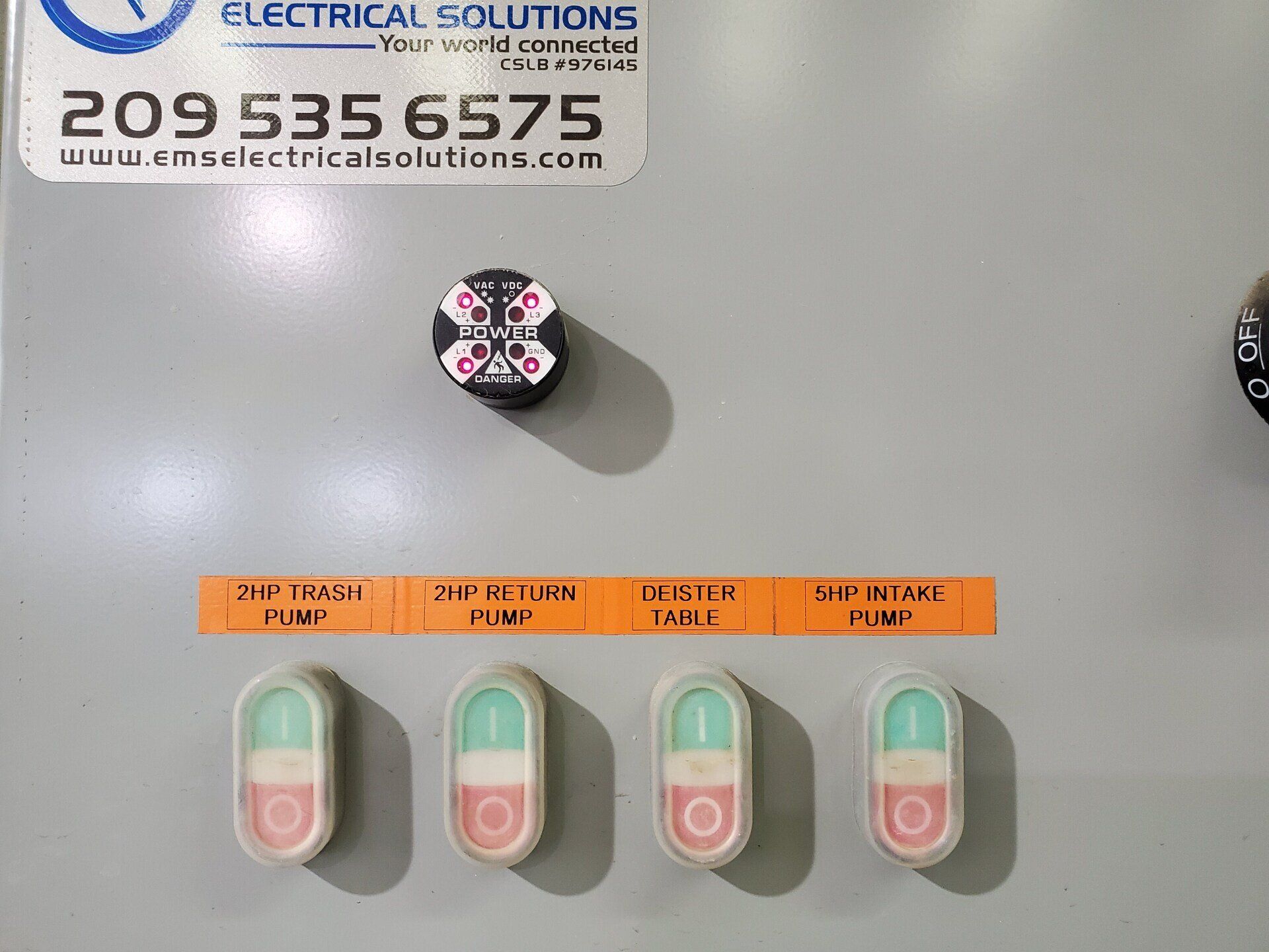 A sticker on a wall that says EMS  electrical solutions