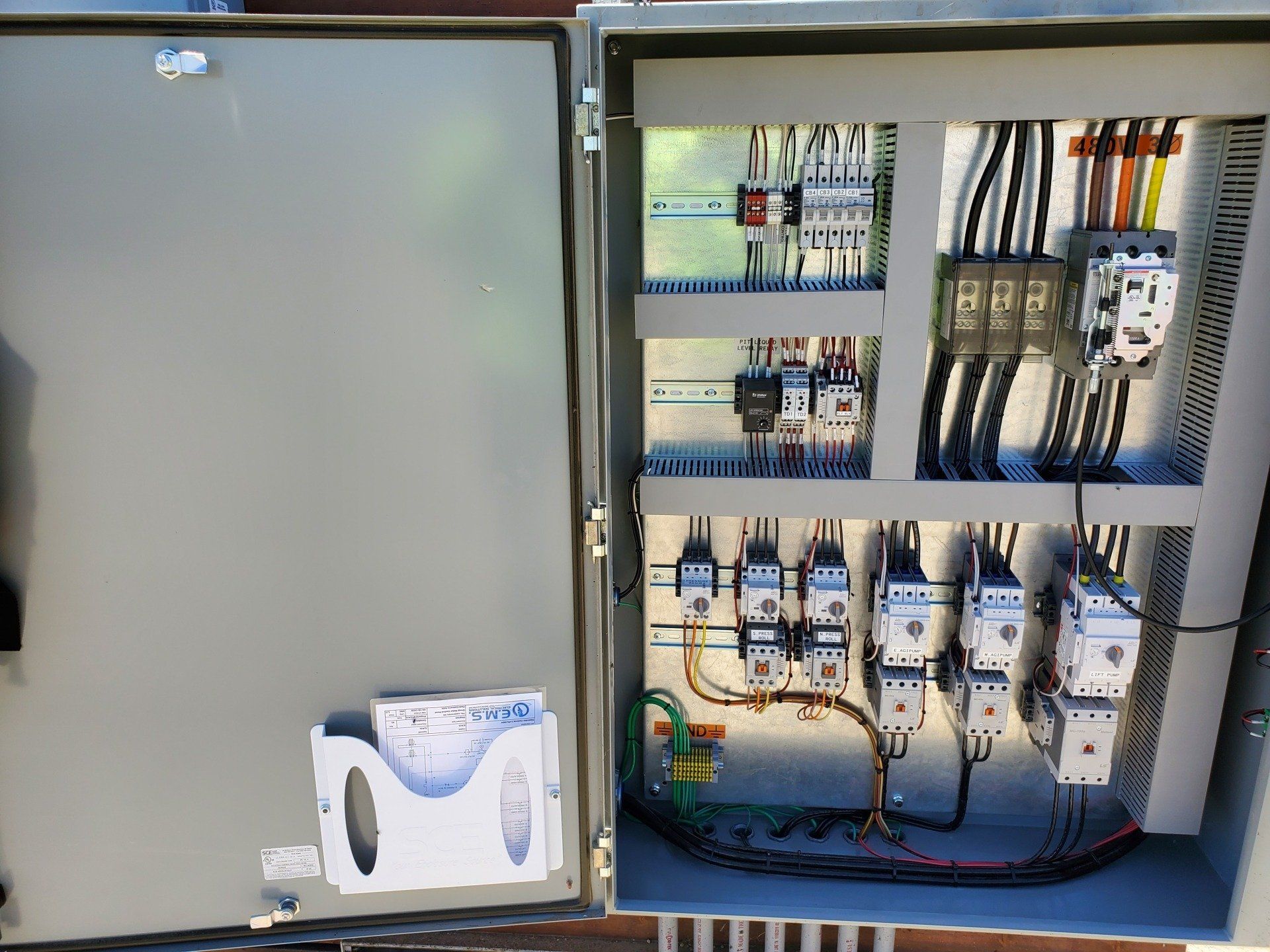 A large electrical box with a lot of wires and switches