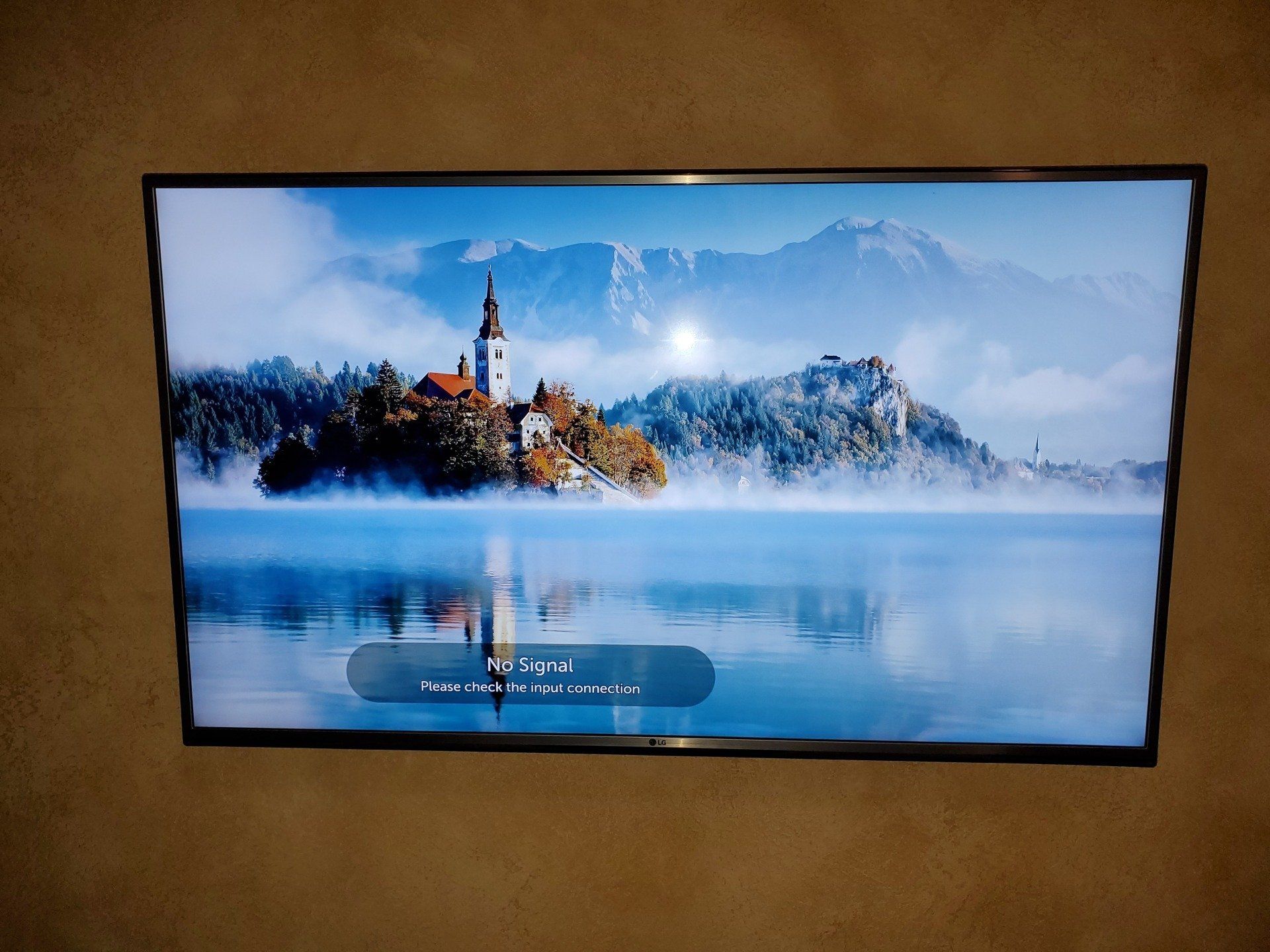 installation of flat screen tv shows a lake with mountains in the background