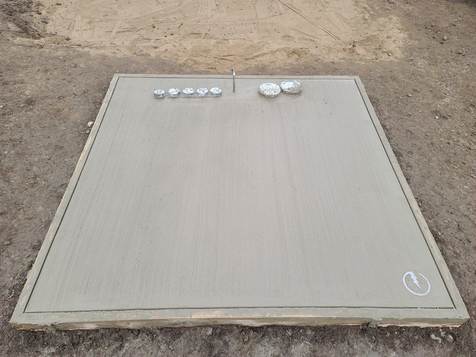 A large concrete slab with EMS logo on corner