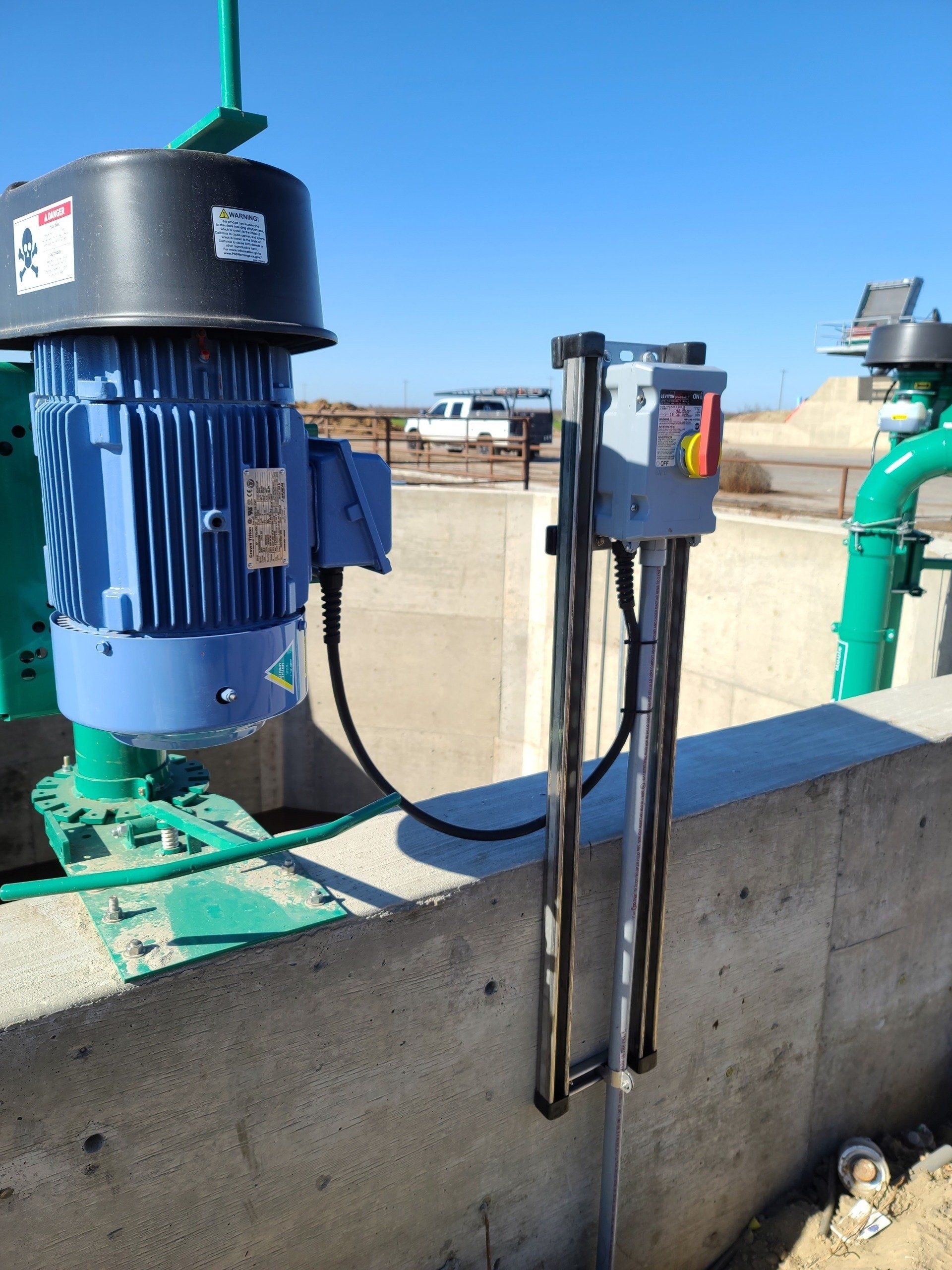 A blue motor is attached to a concrete wall