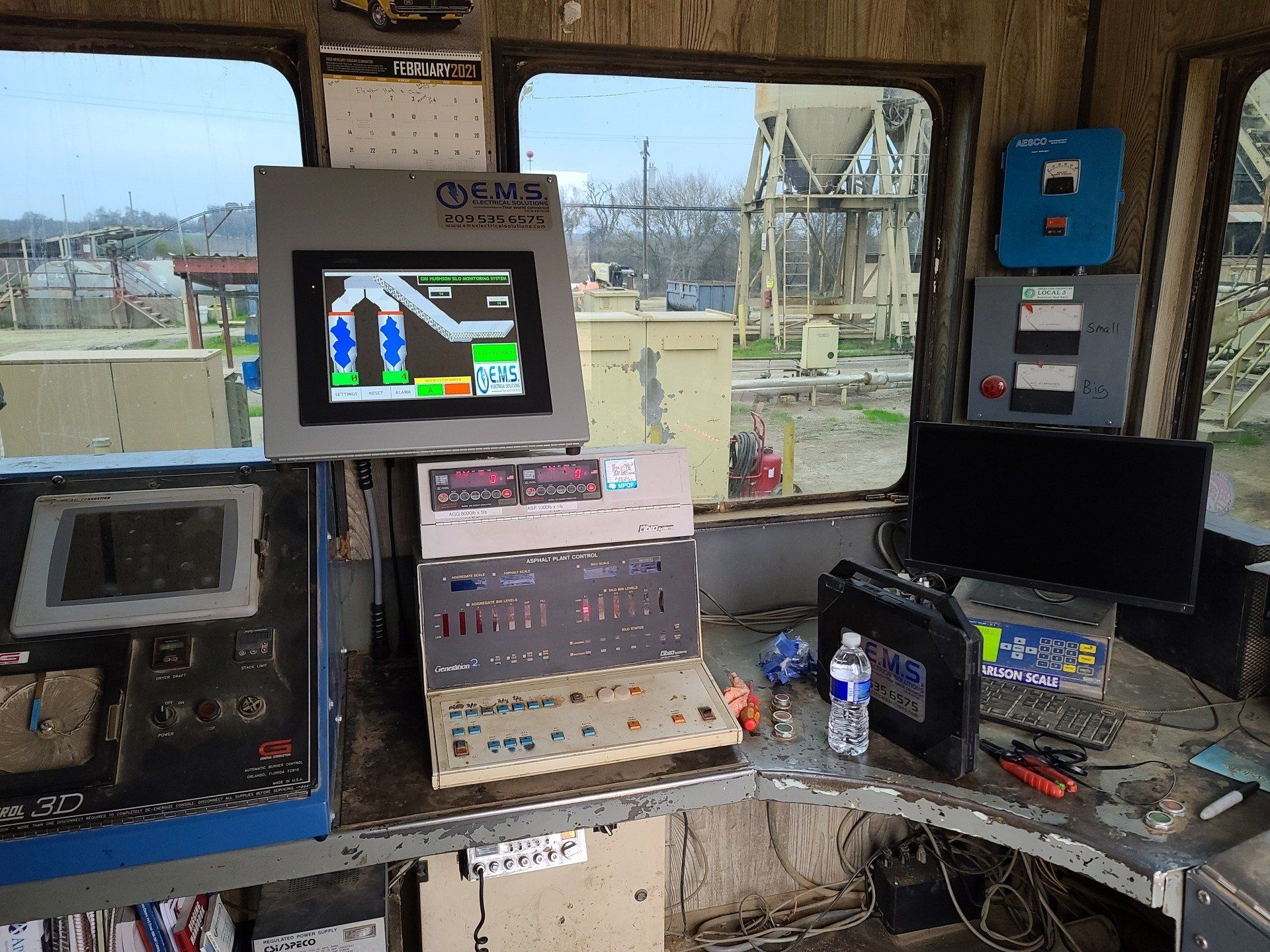 A computer monitor is sitting on top of a table in a room.