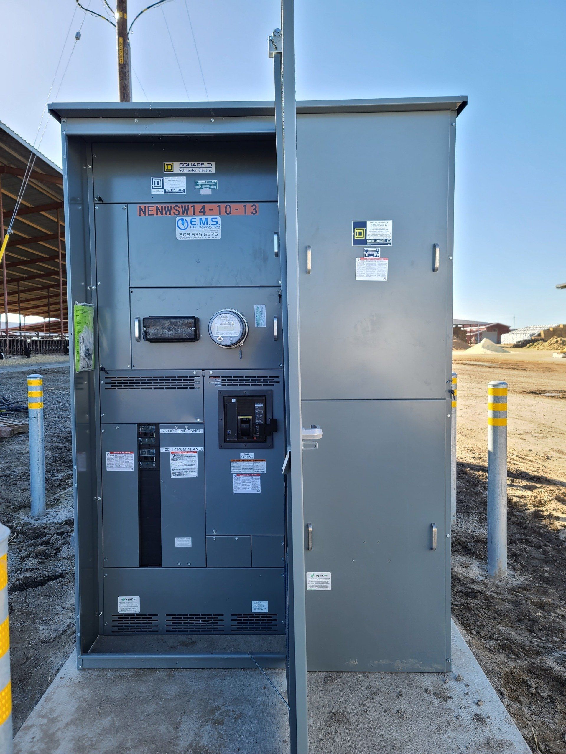A large electrical box is sitting on top of a concrete platform.
