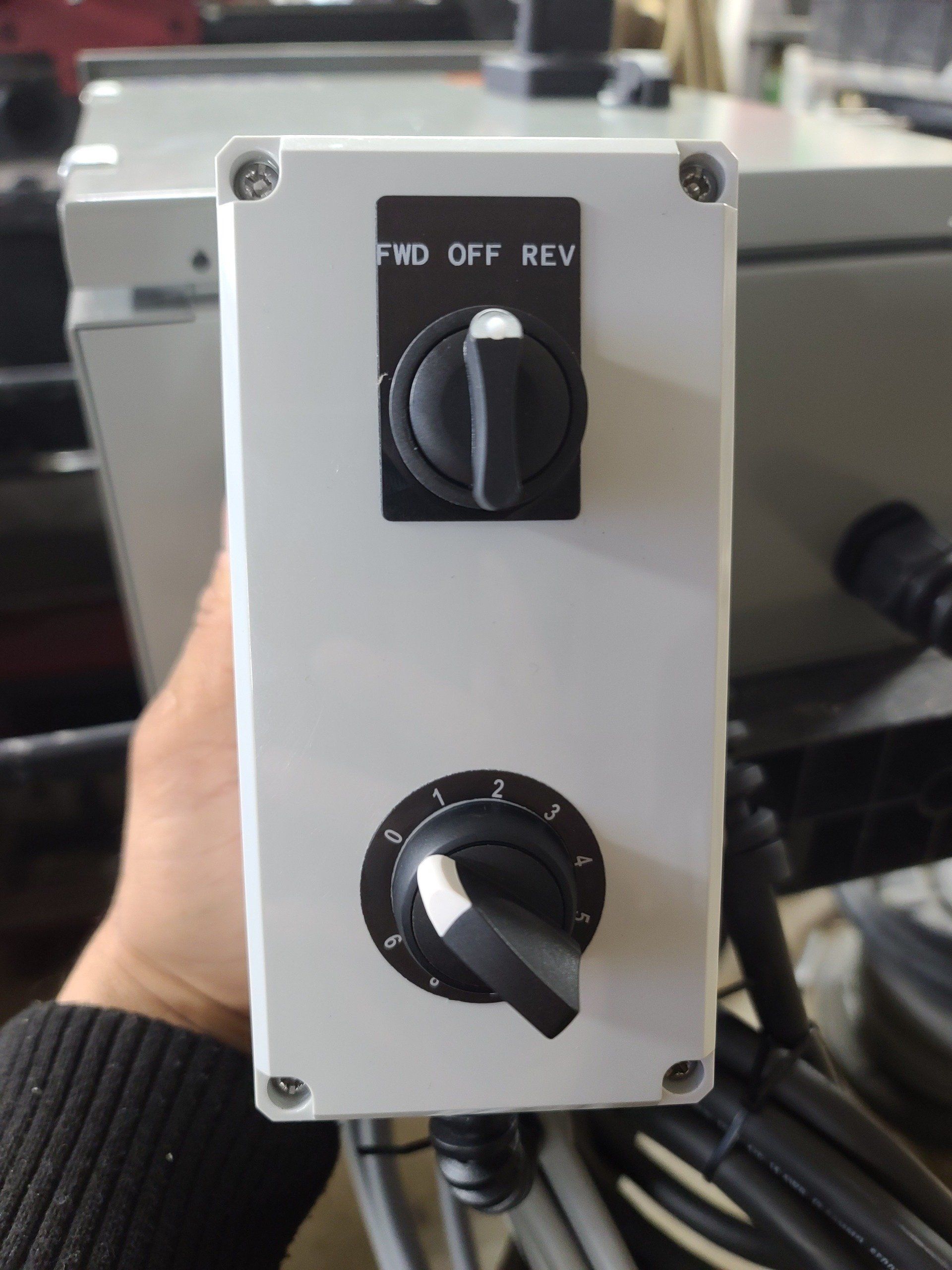 A person is holding a switch that says pvd off rev