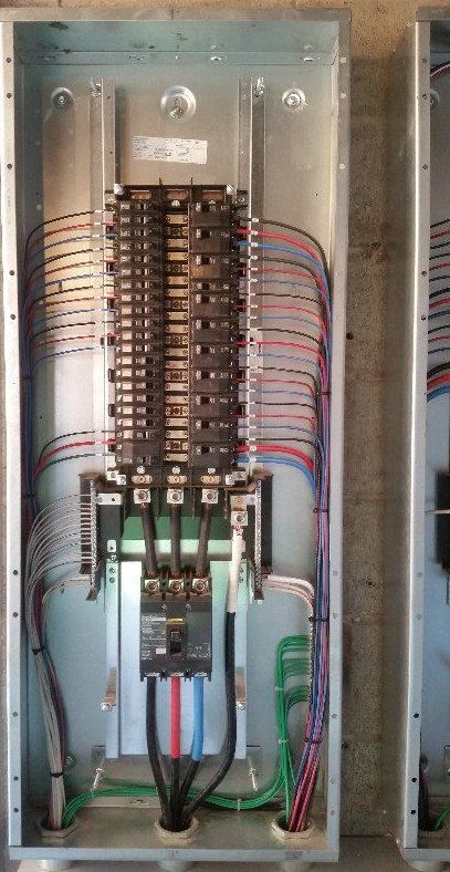 Un quadro elettrico da cui escono molti fili.