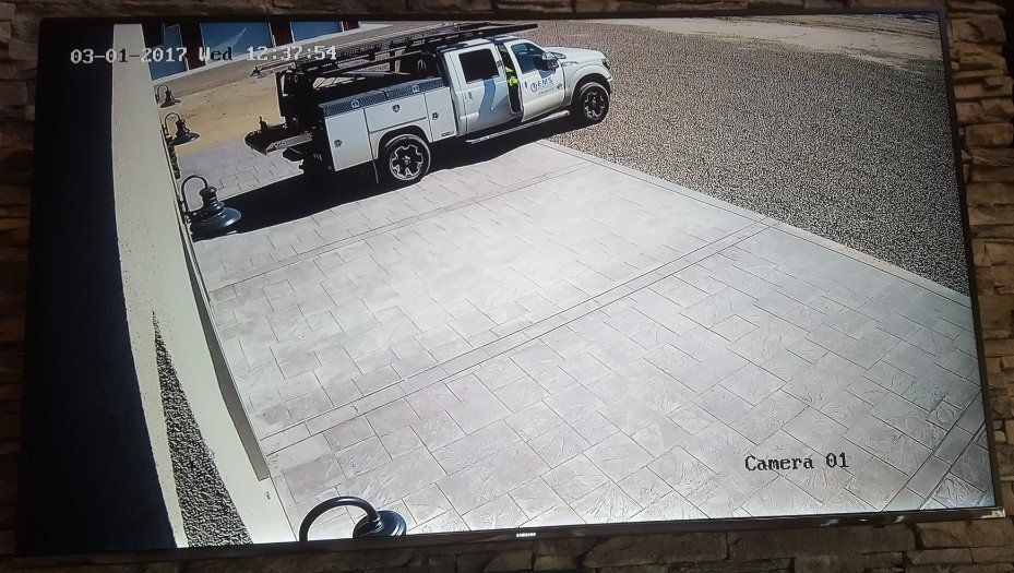 A white truck is parked in a driveway on a monitor