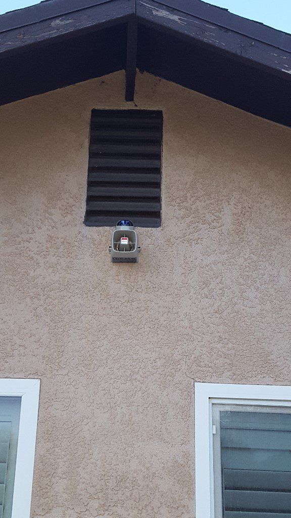 Eine Laterne hängt vom Dach eines Hauses.