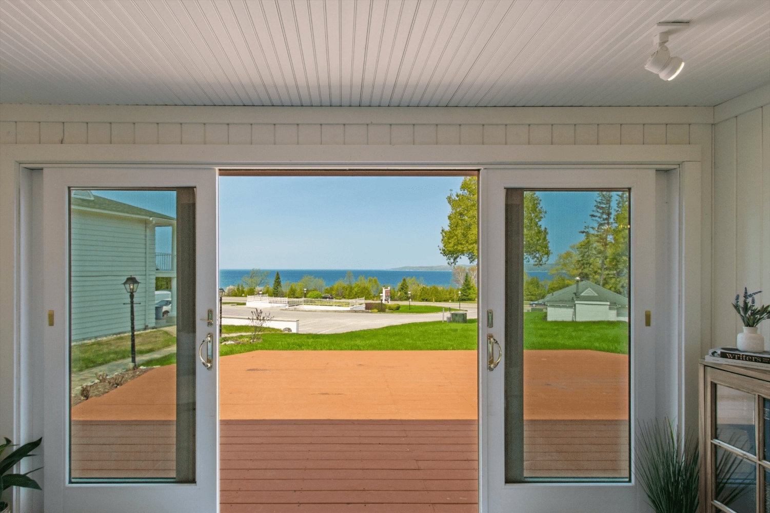 A living room with a view of the ocean through a sliding glass door