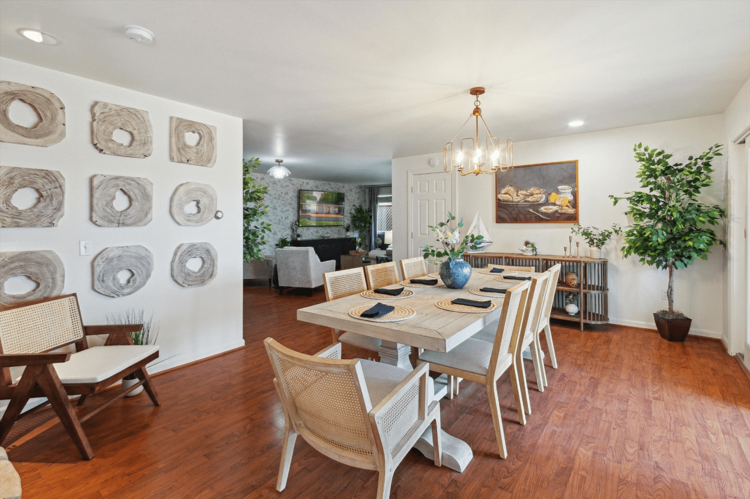 A dining room with a table and chairs and a chandelier.