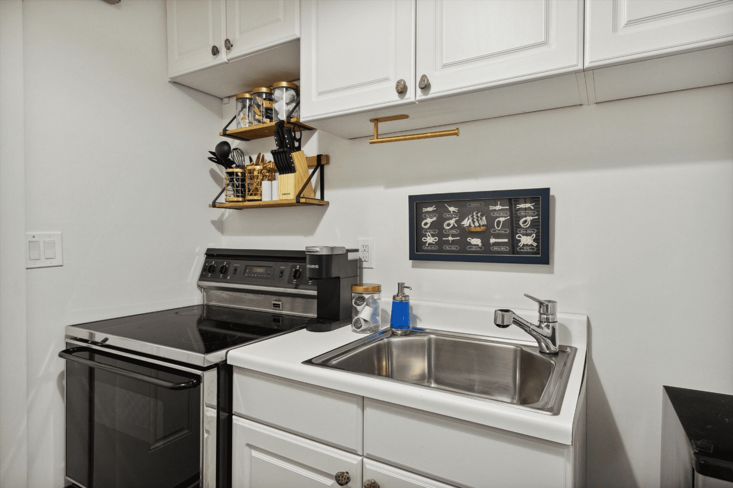 A kitchen with a sink , stove , and oven.