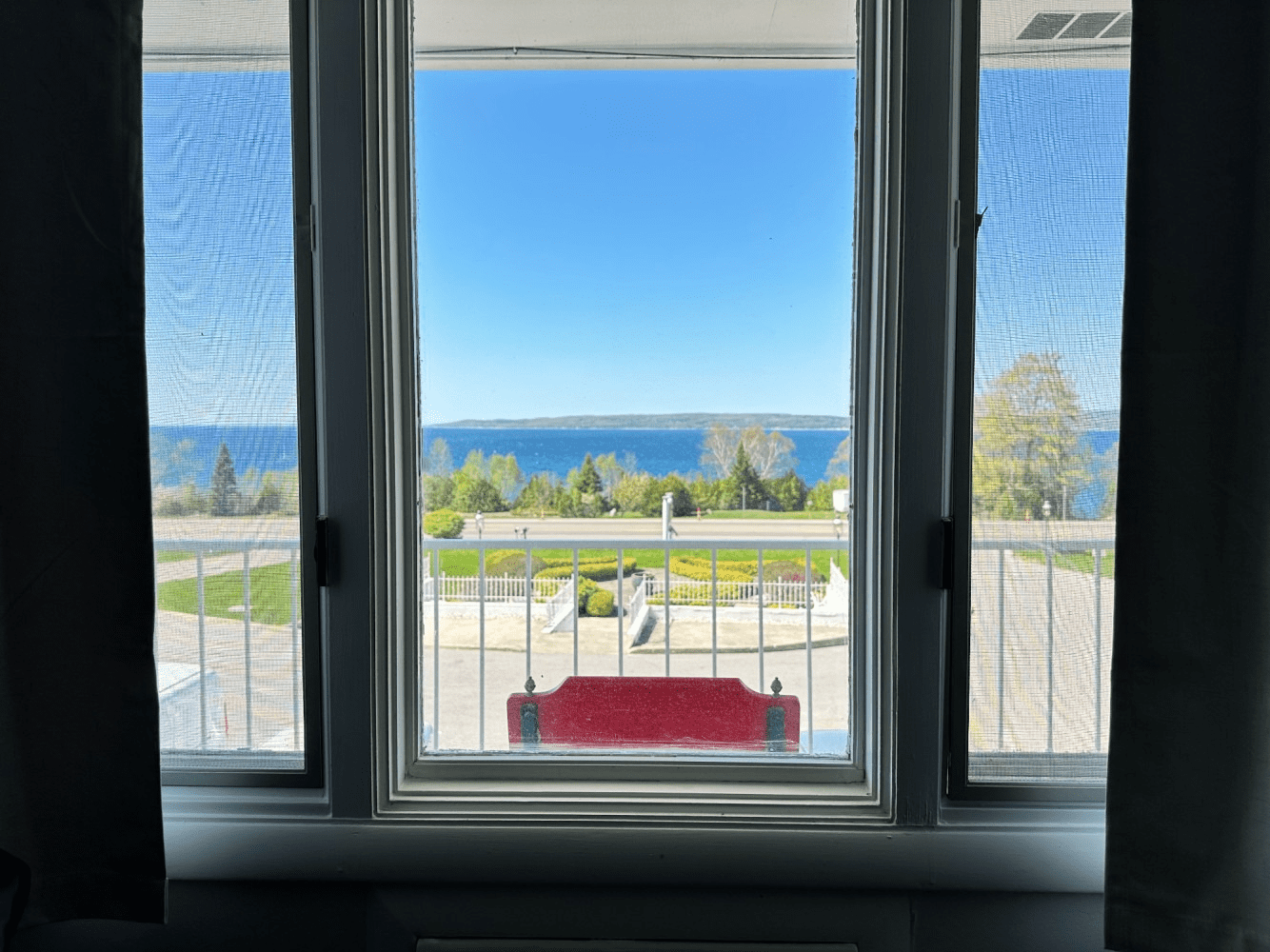 There is a view of the ocean through a window.