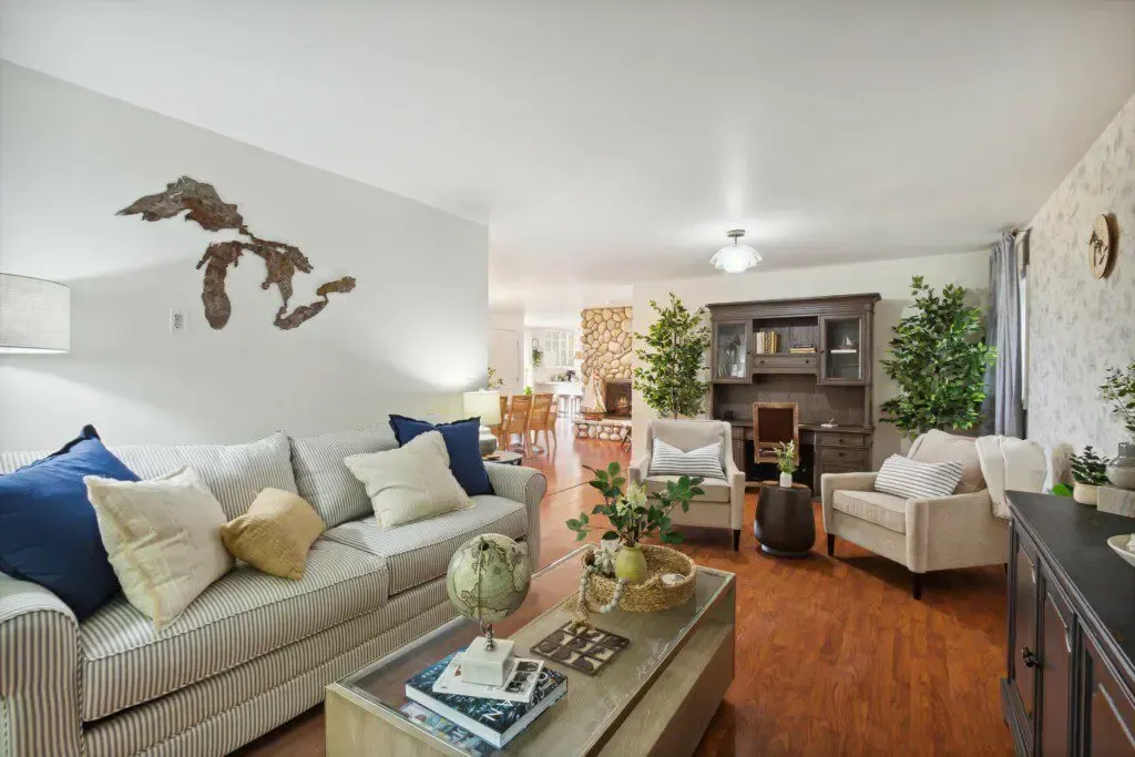 A living room with a couch , chairs , and a coffee table.