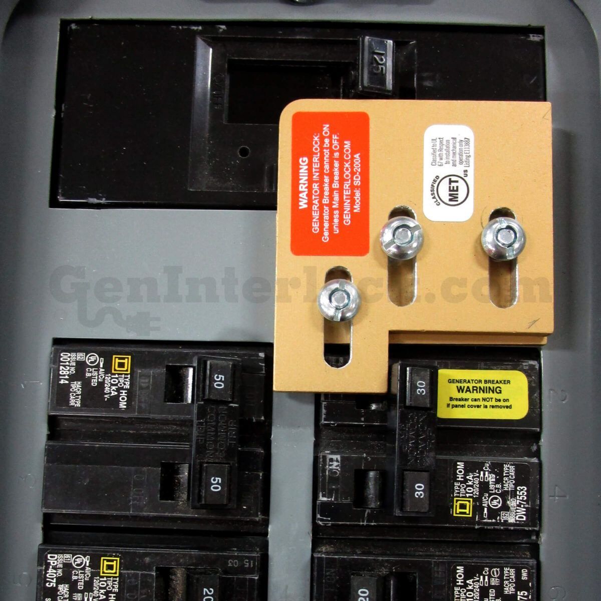 A red generator is sitting on top of a lush green field.