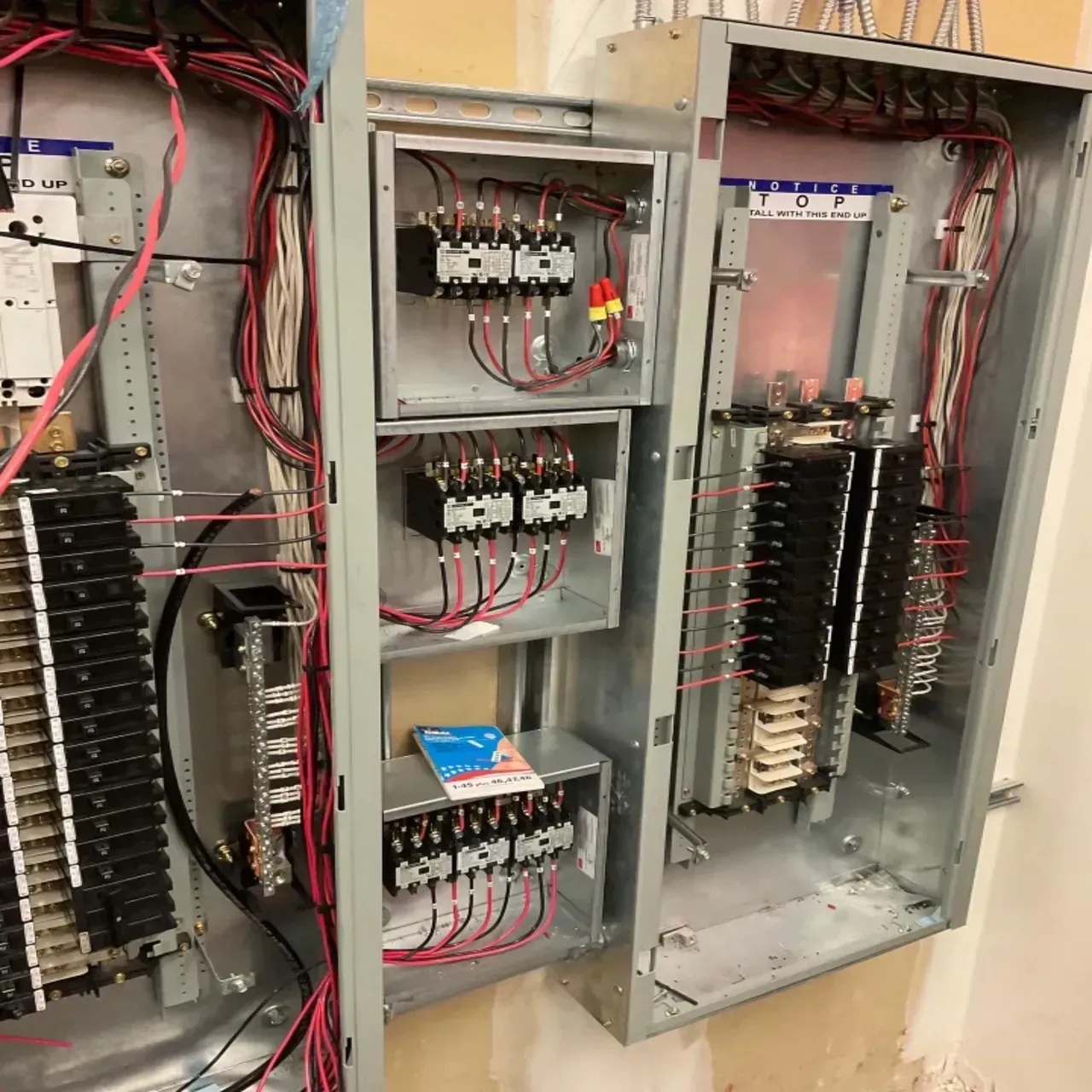 A large electrical box with a lot of wires coming out of it