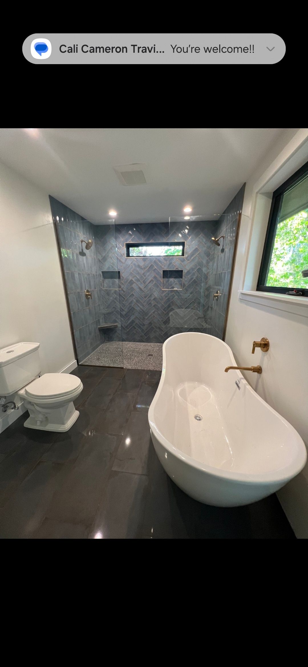 Exterior view of two green mobile homes with a yard in disrepair. Construction equipment is present.