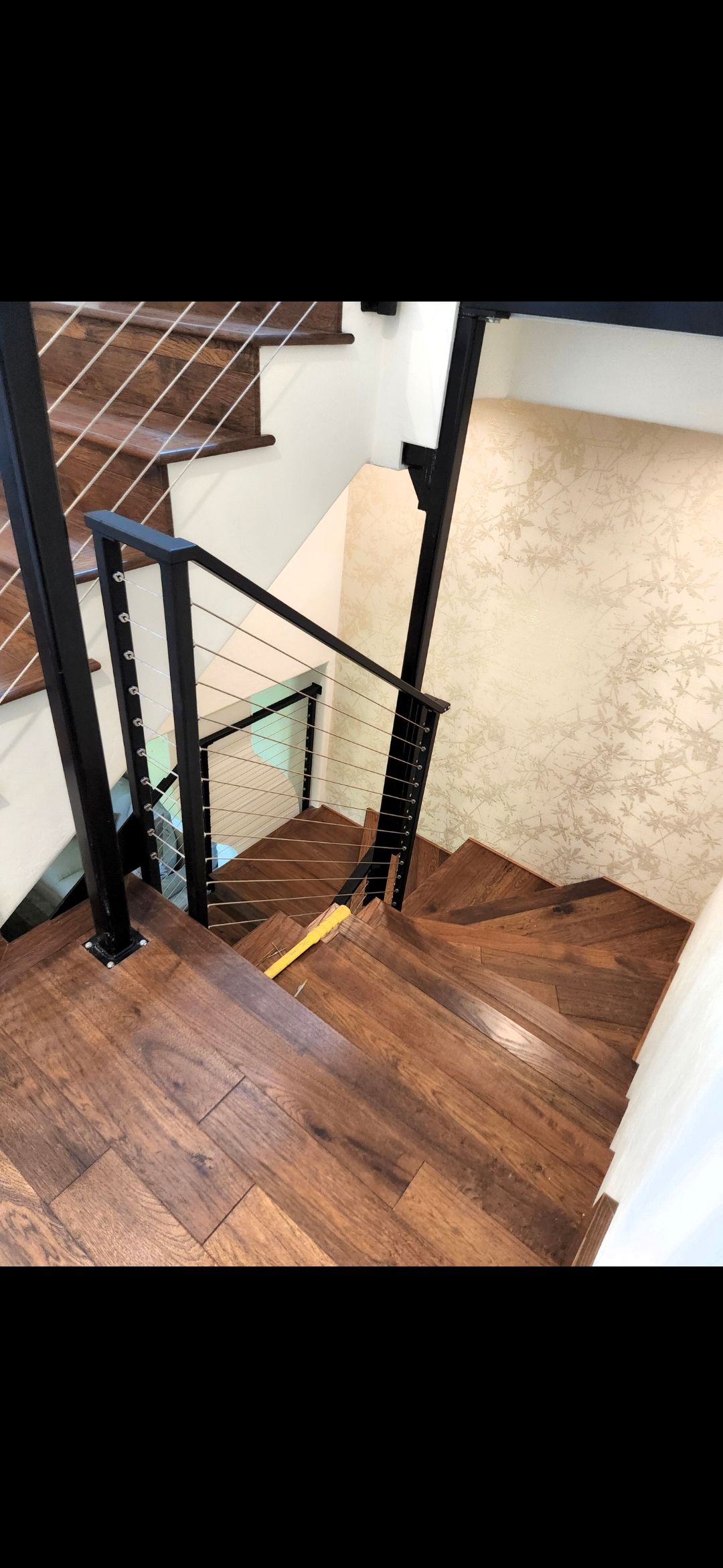 Built-in white bookshelves on a beige carpet, with a skylight above. A red bucket sits in the center.