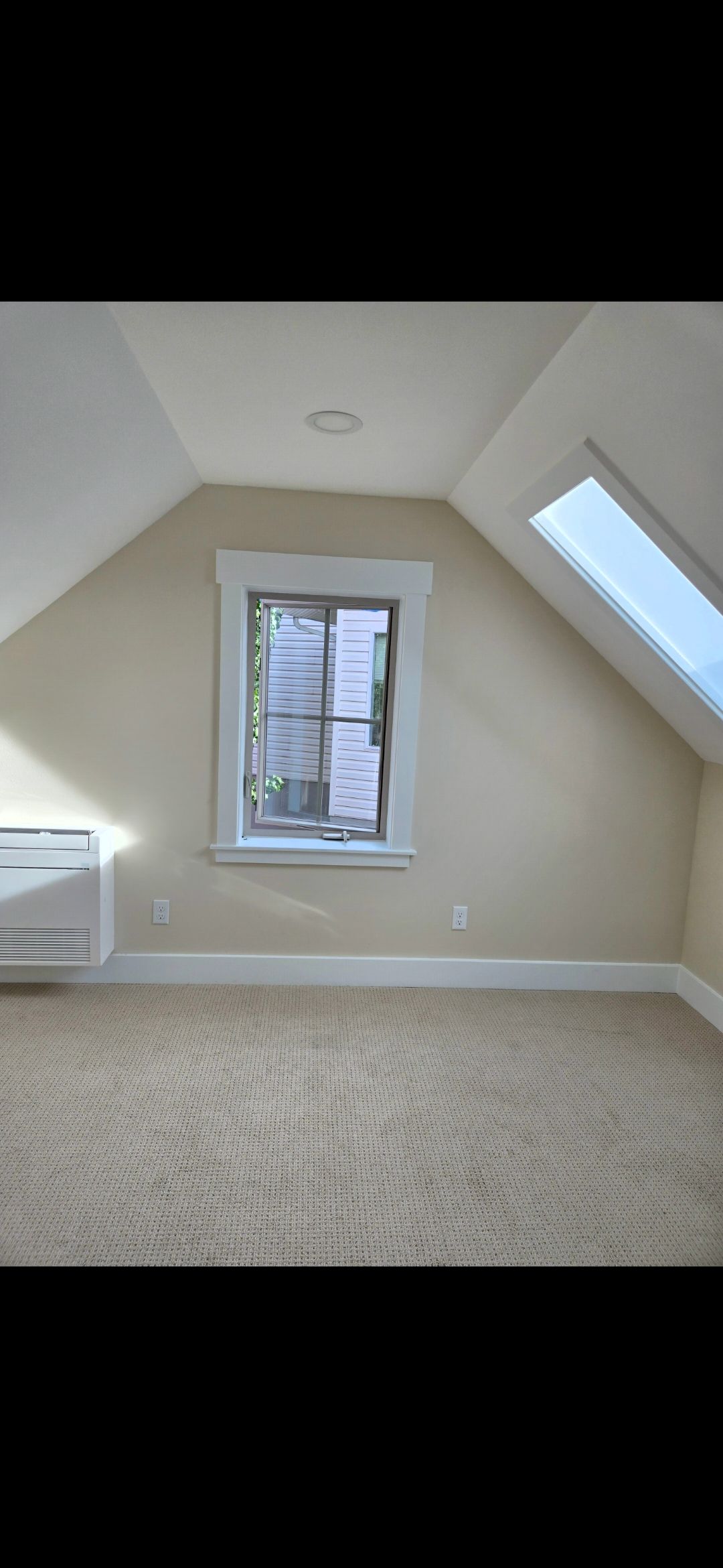Light blue house with a wooden porch and steps, surrounded by green grass.