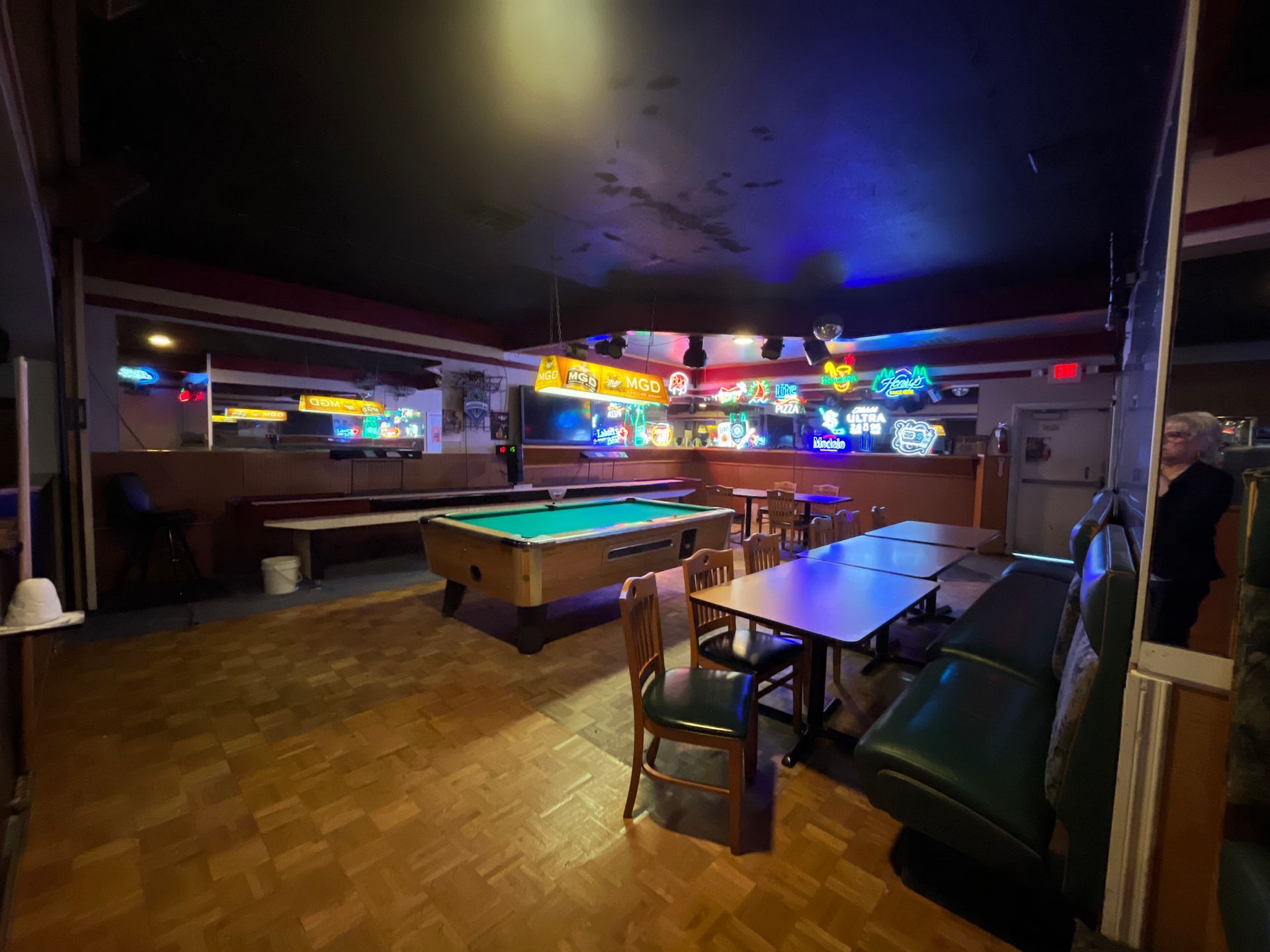 There is a pool table in the middle of the room.