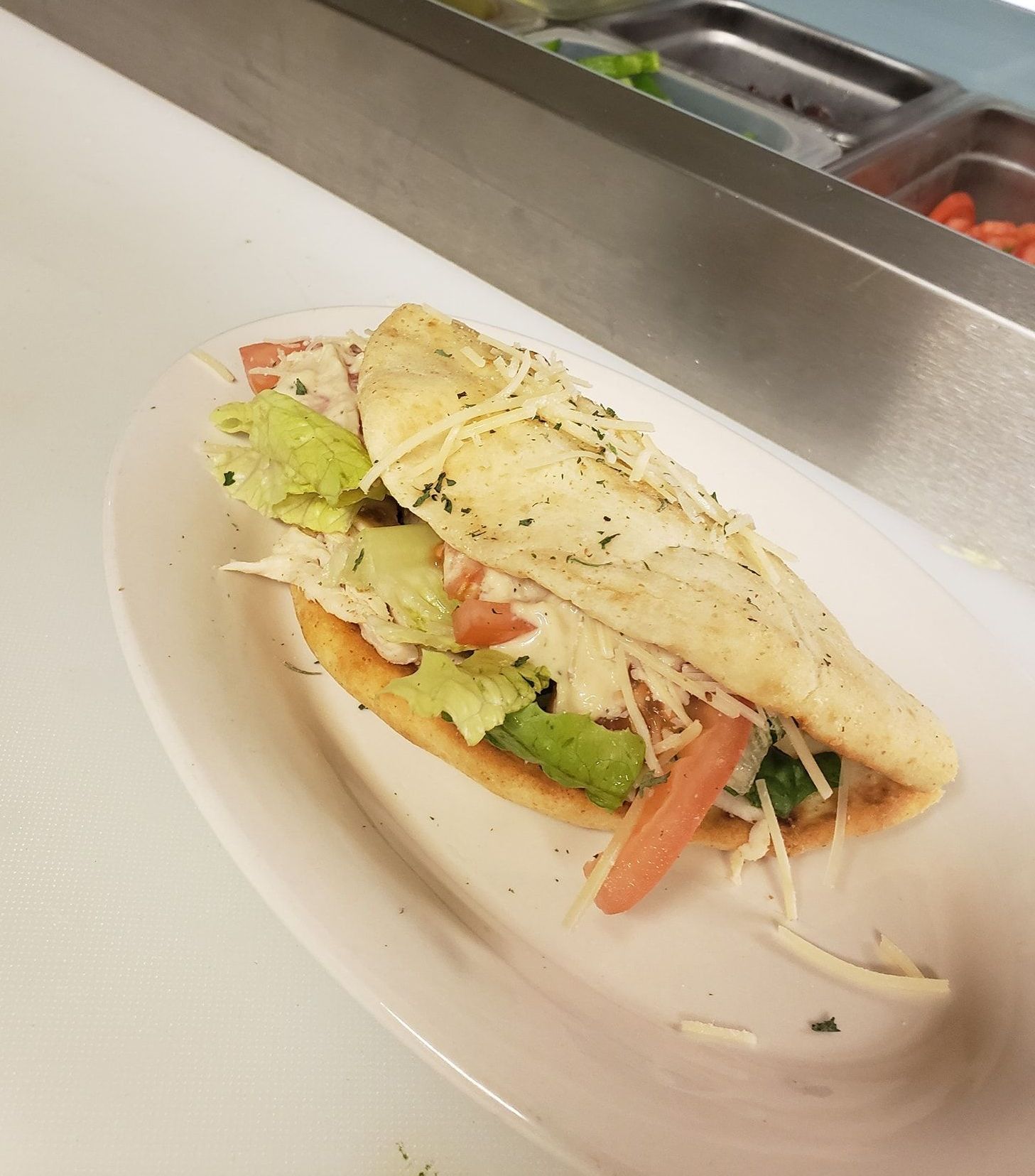 A gyro sandwich  on a white plate