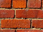 a close up of a red brick wall with a lot of bricks .