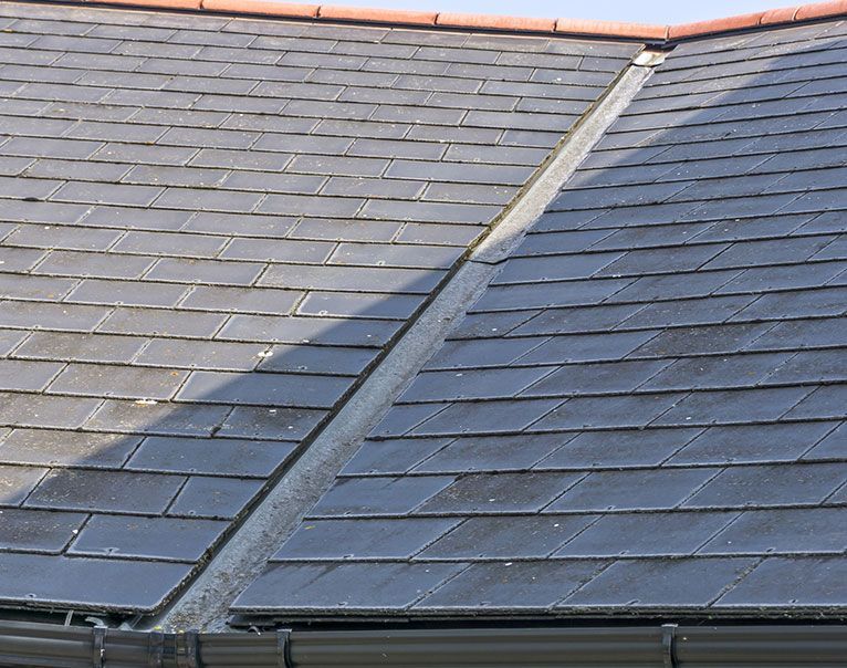 a close up of a roof with slate tiles