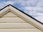 a close up of the roof of a house with a blue sky in the background .