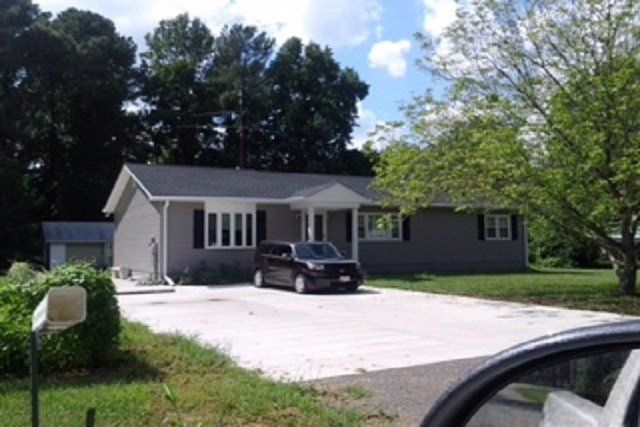 After new addition with new concrete driveway
