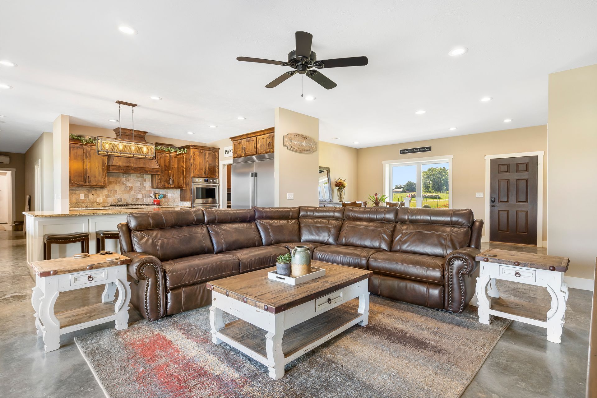 A living room with a couch , coffee table , and ceiling fan - custom icf homes near me in Republic MO