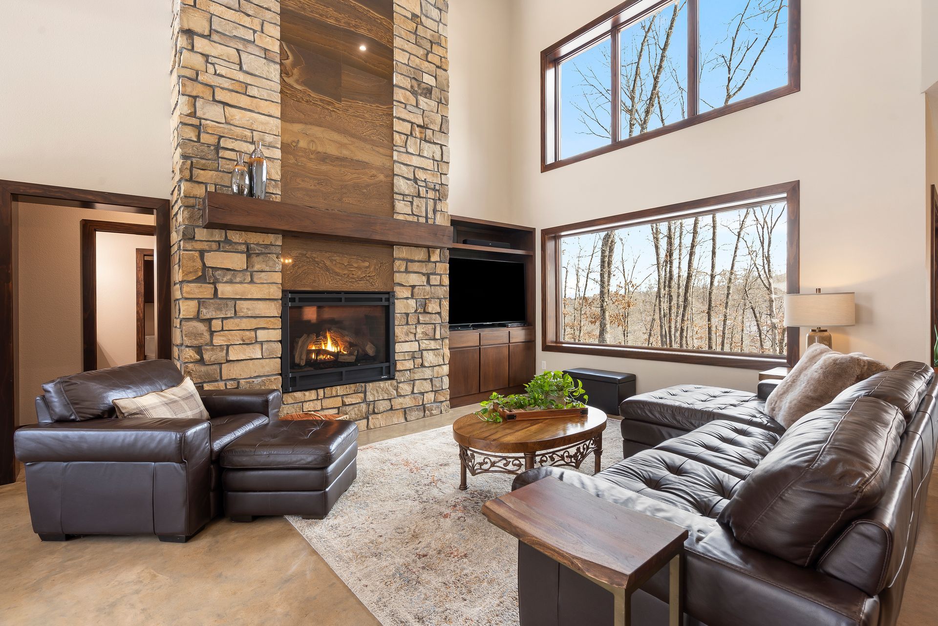Large stone gas fireplace with inlaid luxury tile in Ozarks ICF home | Sparta, MO