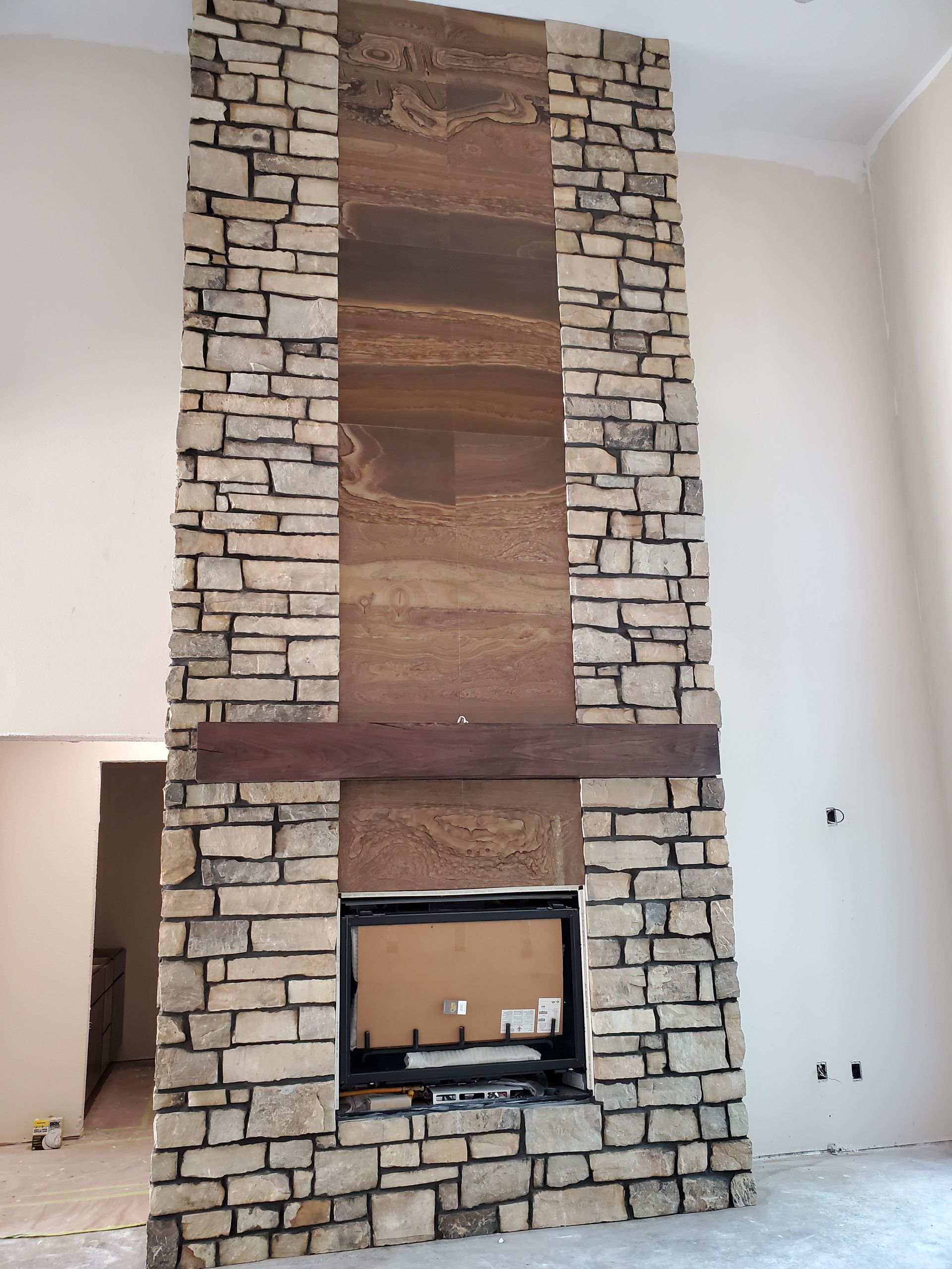 Stone fireplace and drywall being installed in an ICF home in Sparta, MO