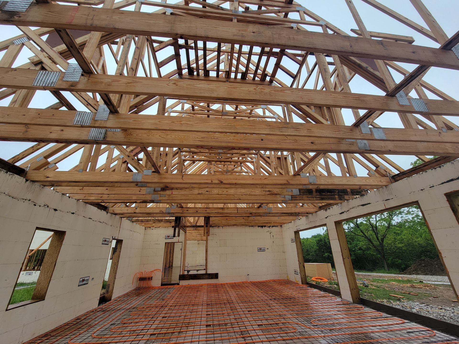 The inside of a building under construction with wooden beams and brick floors- Roofs with ICF in Springfield 