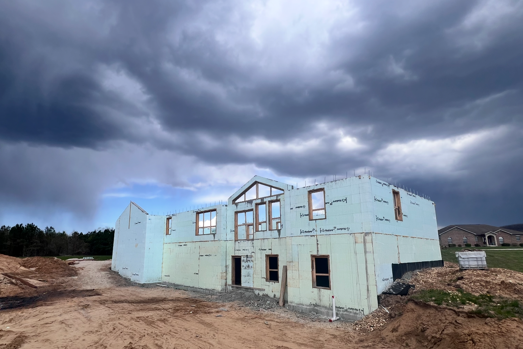 Insulated concrete form custom home under storm clouds | Hermann, MO