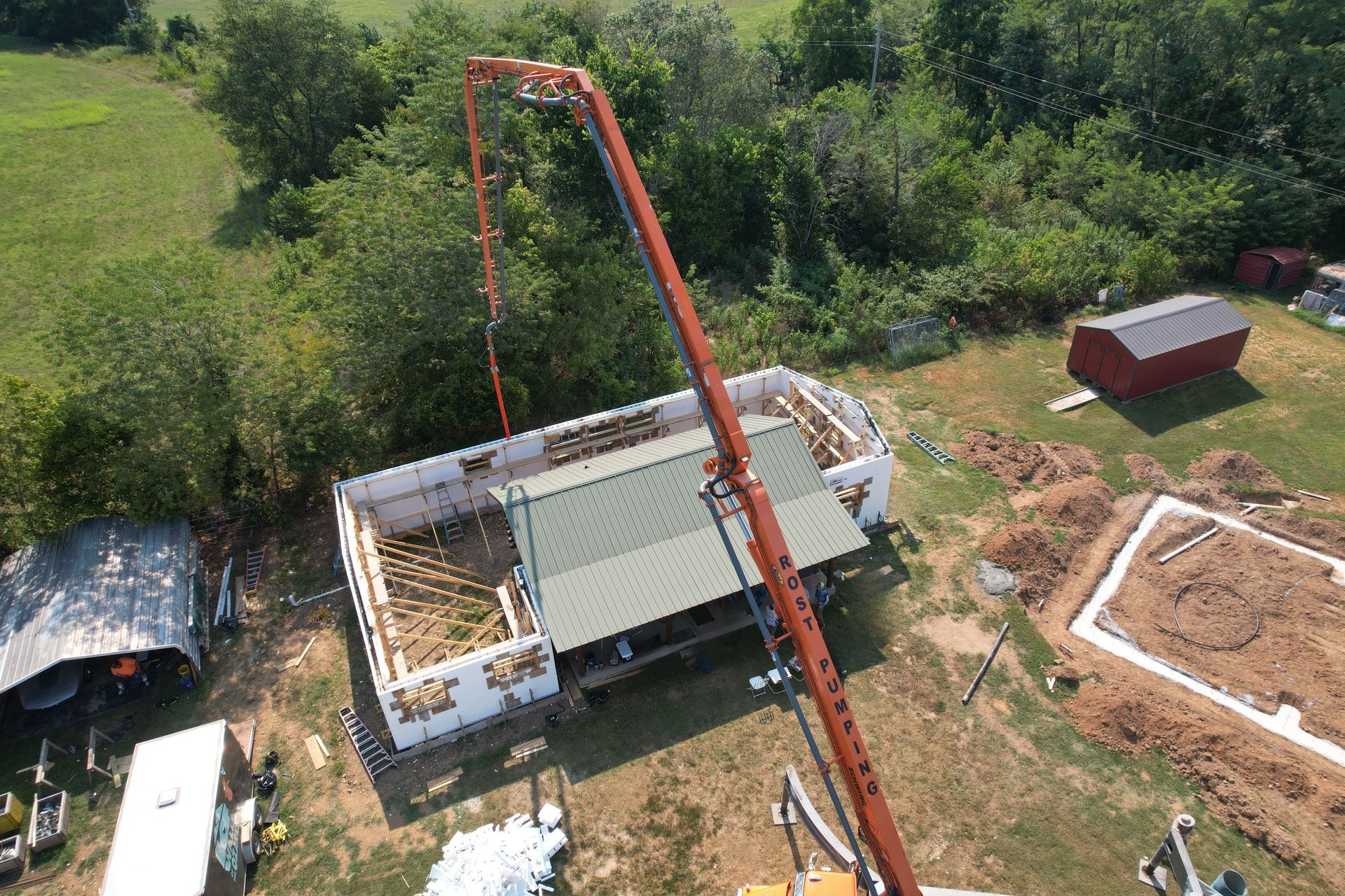 ICF walls being filled with concrete on log cabin home addition | Northwest Arkansas