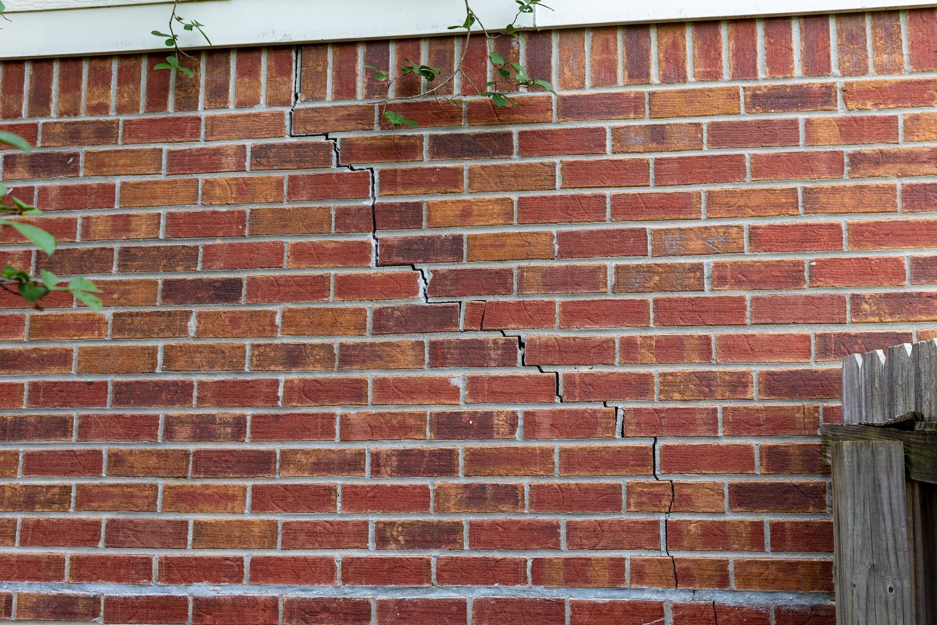 Cracked brick foundation on traditional home 