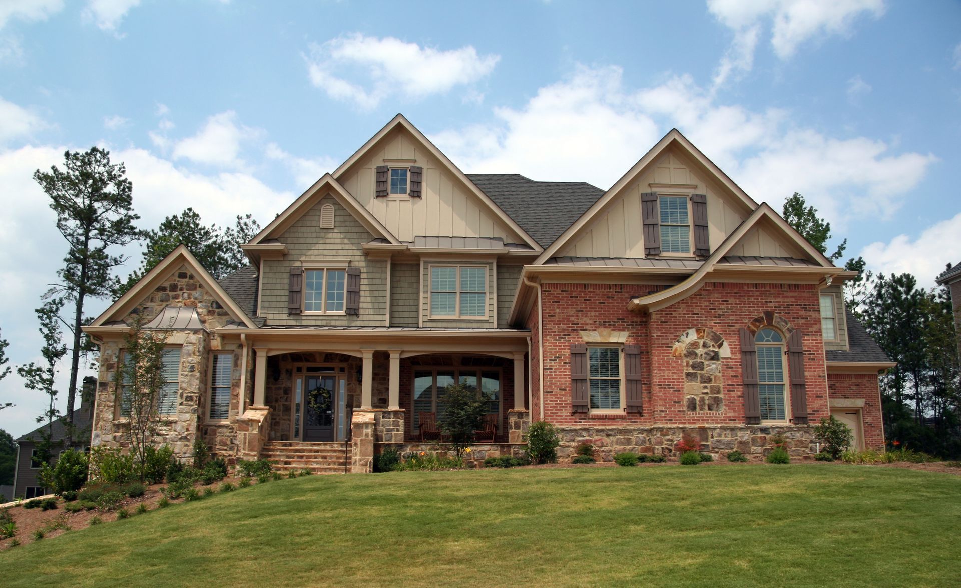 Custom home with mixed exterior brick, stone, board and batten vertical siding | Springfield, MO