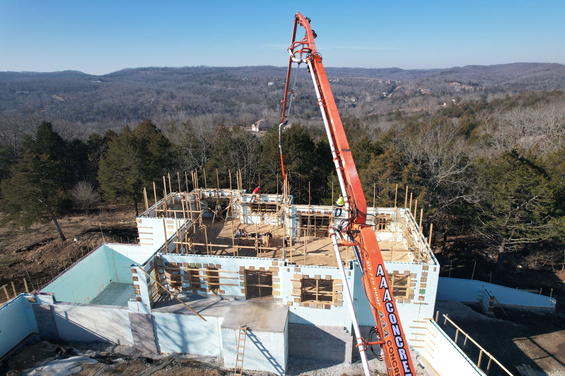 Concrete home under construction surrounded by trees | Willard, MO